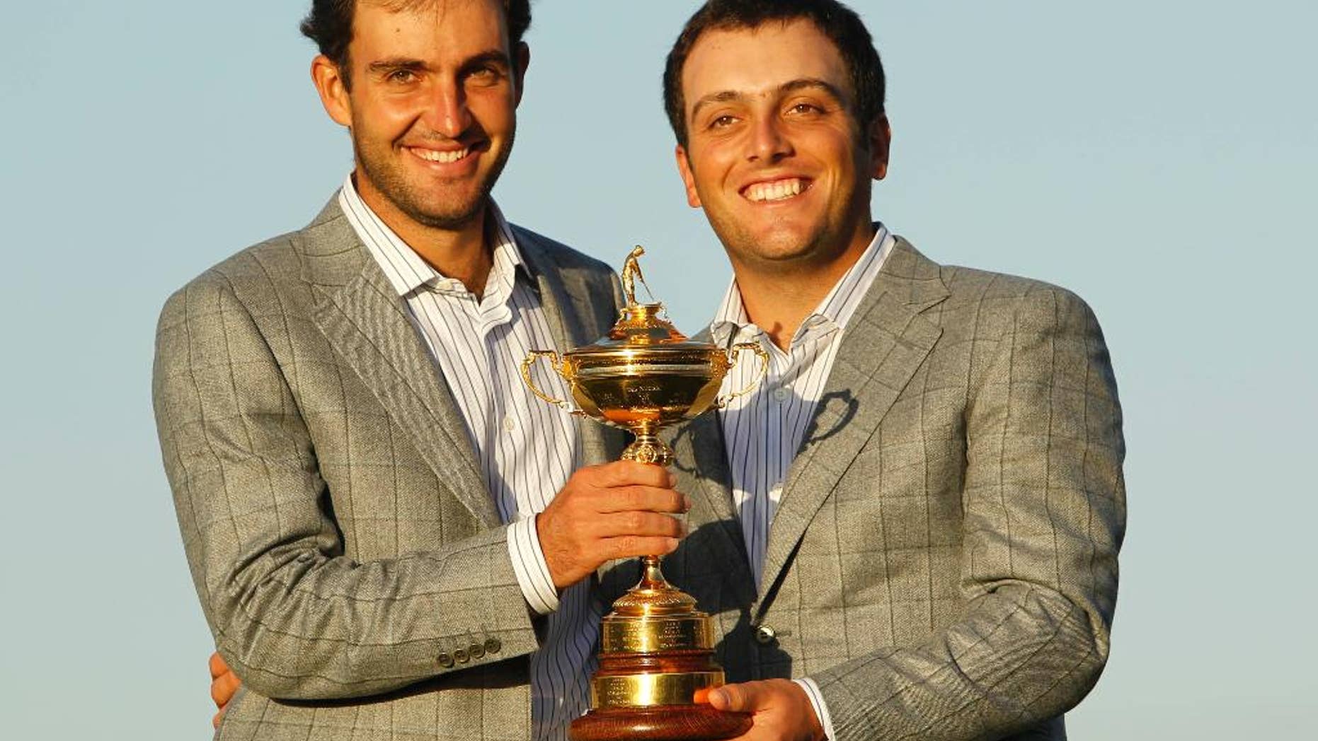 FILE - This is a Monday, Oct. 4, 2010 file photo of Europe's Edoardo Molinari, left, and Francesco Molinari, brothers from Italy, as they hold the trophy after Europe won the 2010 Ryder Cup golf tournament at the Celtic Manor Resort in Newport, Wales. The Ryder Cup is headed to Italy for the first time, with the Marco Simone club in Rome chosen Monday to host golf's biggest team event in 2022. Italy beat rival bids from Germany, Spain and Austria to secure hosting rights for the 44th edition of the biennial competition between Europe and the United States. (AP Photo/Jon Super, File)
