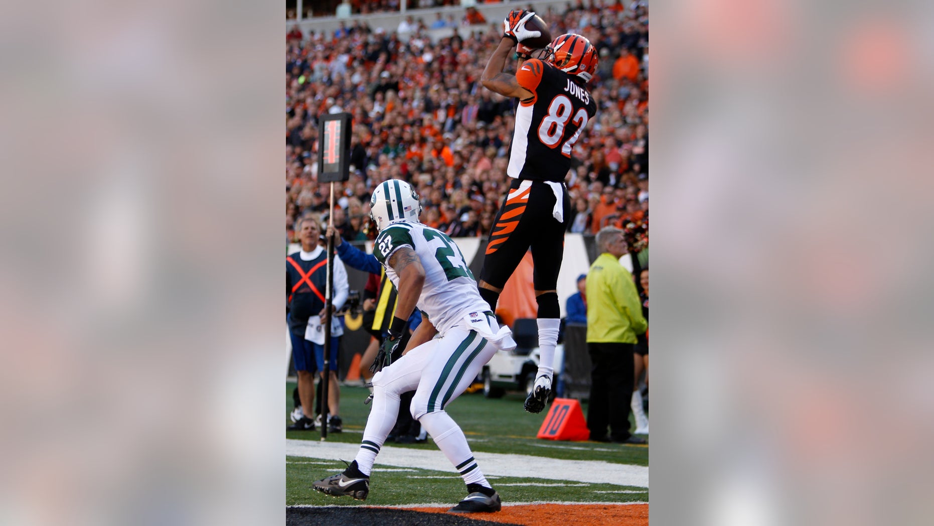 Cincinnati Bengals wide receiver Marvin Jones (82) catches a nine-yard touchdown pass against New York Jets cornerback Dee Milliner (27) in the first half of an NFL football game, Sunday, Oct. 27, 2013, in Cincinnati. (AP Photo/David Kohl)