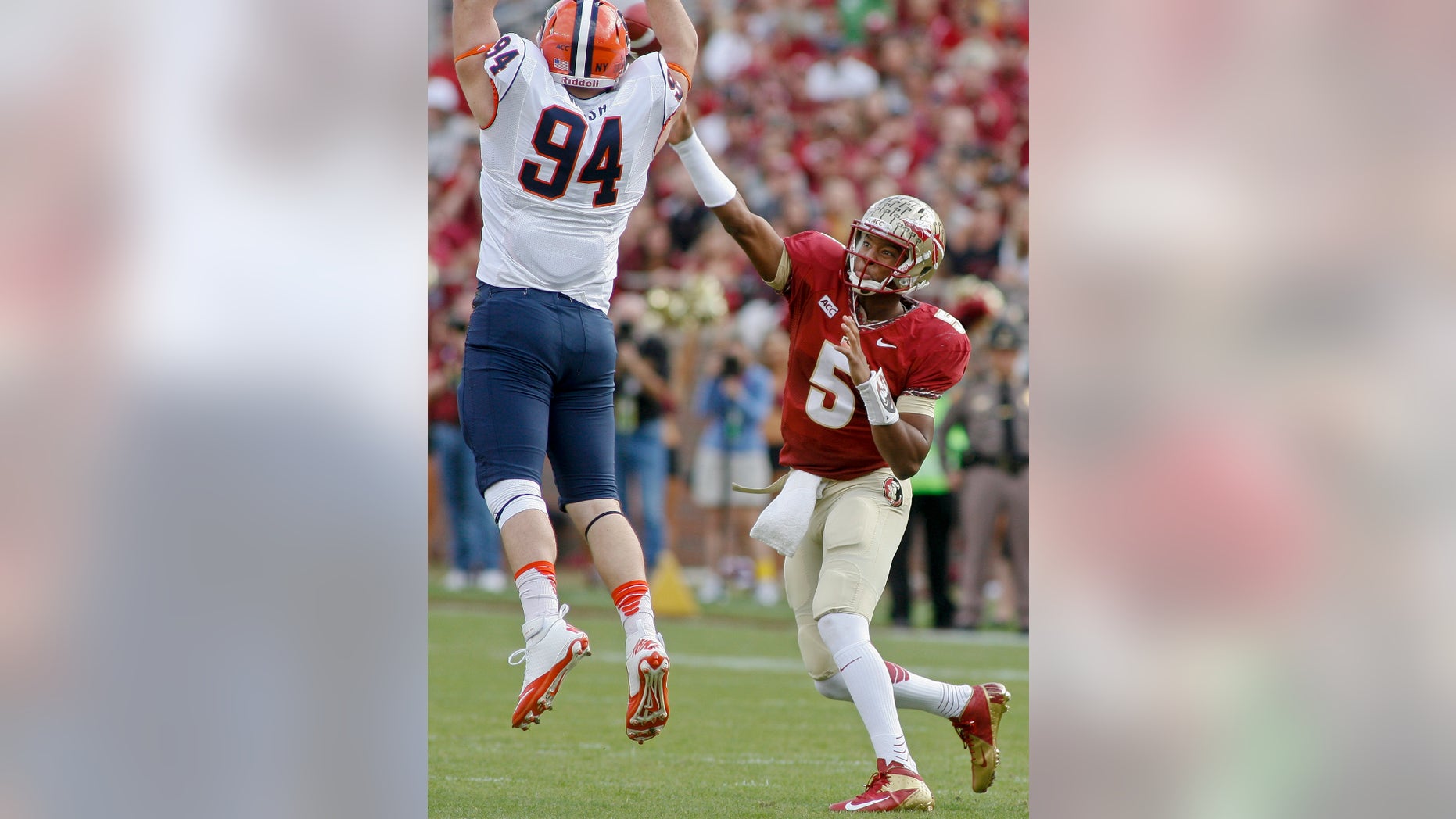 Florida State quarterback Jameis Winston (5) gets off a pass as Syracuse defensive end Robert Welsh (94) attempts to block it in the first quarter of an NCAA college football game on Saturday, Nov. 16, 2013, in Tallahassee, Fla. (AP Photo/Phil Sears)