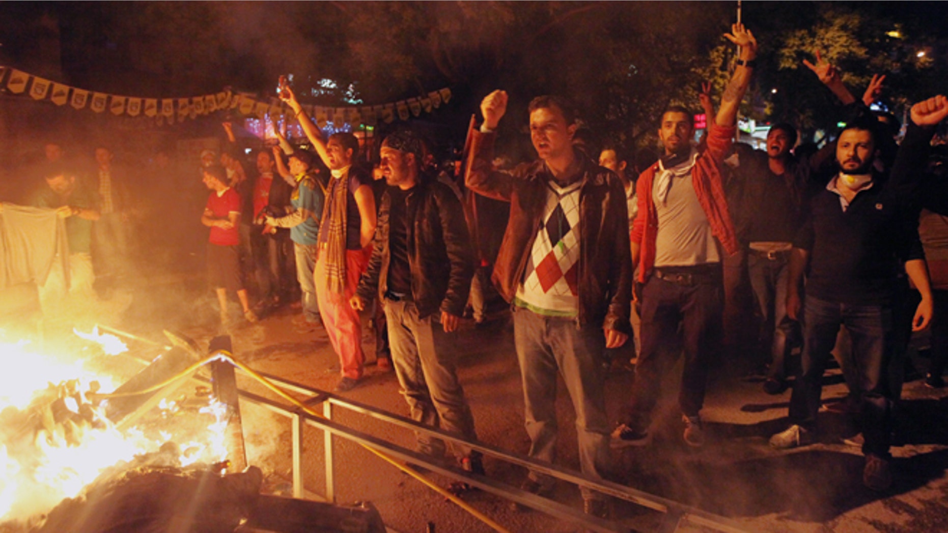 June 9, 2013: Turkish protesters gather at a barricade before they clash with riot police stationed on the John F. Kennedy Street, in front of the U. S. embassy in Turkish capital, Ankara. Tens of thousands of people thronged Istanbul's Taksim Square Saturday, and thousands more turned out in central Ankara as protests that have presented Turkish Prime Minister Recep Tayyip Erdogan with the first serious challenge to his leadership entered their second week.