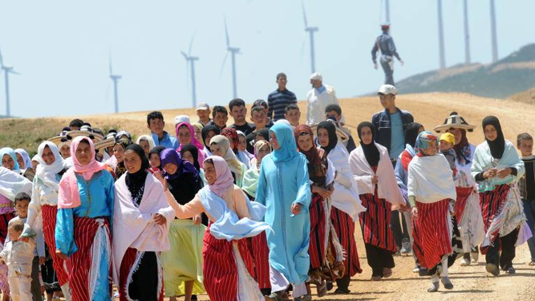 Villagers of Dahr Saadane walk in front of the wind farm on June 28, 2010 in Tangiers.