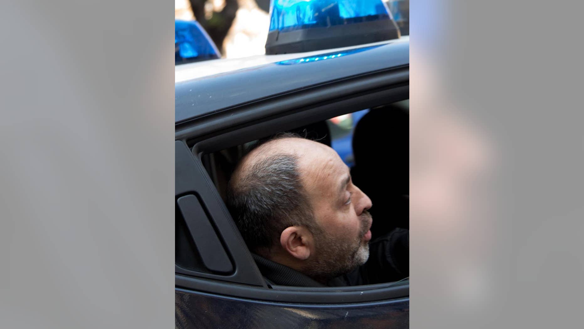 Fugitive mobster Santo Vottari is taken into custody by Italian Carabinieri after they found him hiding in a cramped crawl space behind a trap door of a bunker in an apartment building in the southern Italian town of Ricciolino di Benestare, Wednesday, March 22, 2017. Vottari, who, according to authorities, is tied to a crime clan involved in a 2007 massacre of 6 Italians in Duisburg, Germany, had been convicted in absentia of mafia-like association. (Marco Costantino/ANSA via AP)