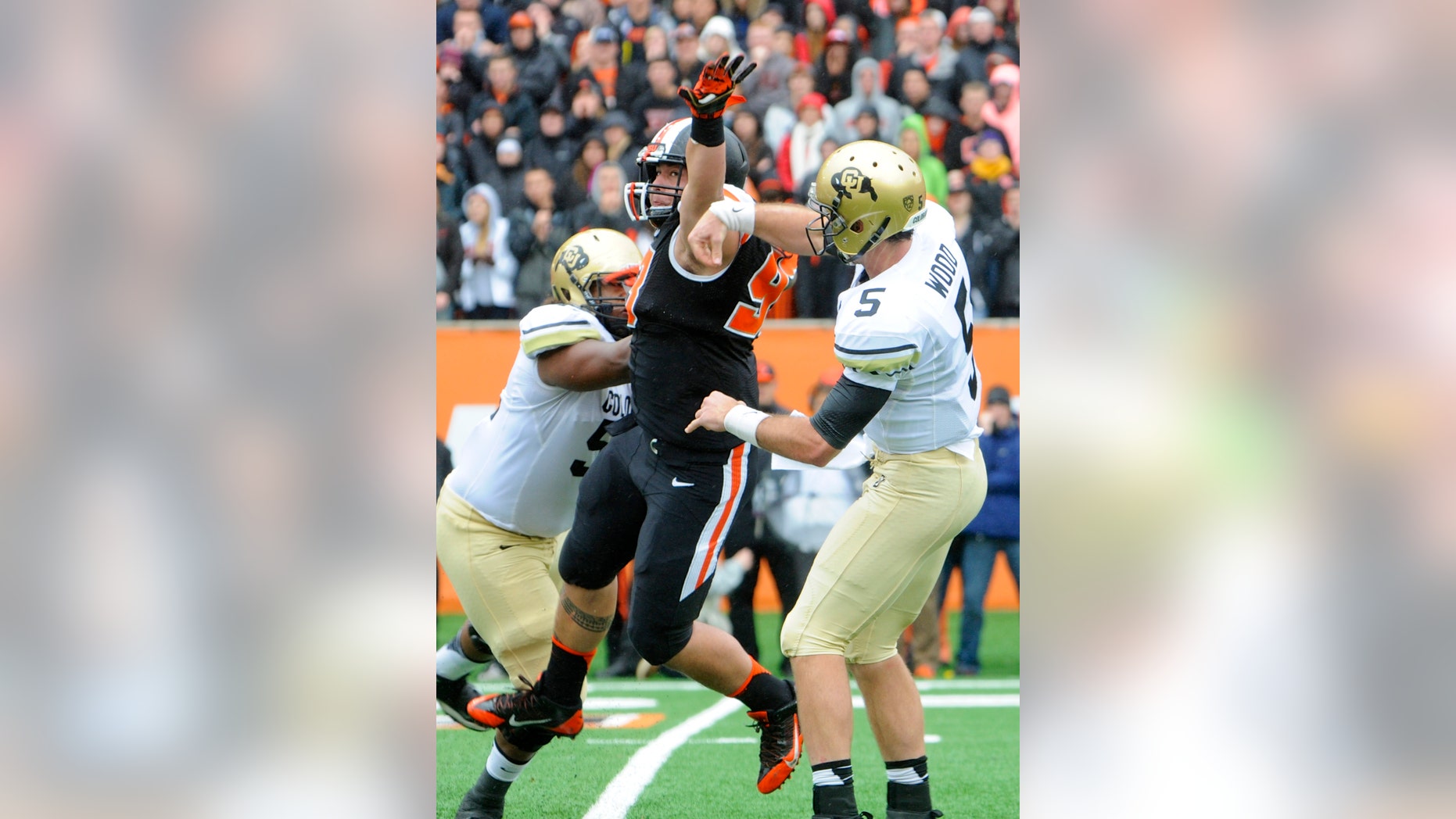 Oregon State's Mana Rosa (93) deflects a throw by Colorado quarterback Connor Wood (5) in the first half of an NCAA college football game on Saturday, Sept 28, 2013, in Corvallis, Ore. (AP Photo/Greg Wahl-Stephens)