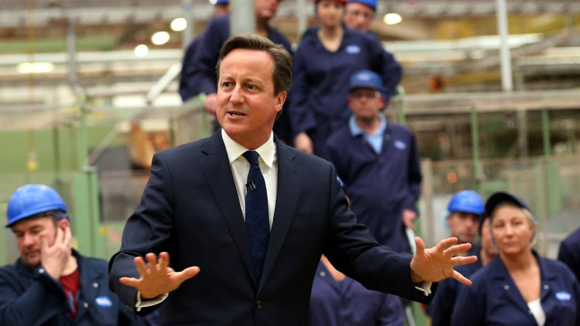 Britain's Prime Minister David Cameron talks to staff during a visit to a tea factory in Stockton-on-Tees, England, Tuesday May 12, 2015, his first engagement outside London since winning the general election. (Scott Heppell/Pool Photo via AP)