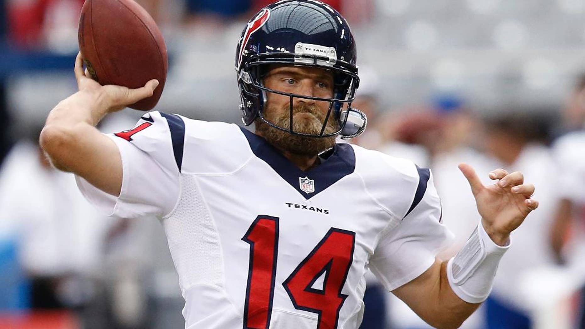 Houston Texans' Ryan Fitzpatrick throws a pass as he and teammates warm up prior to an NFL preseason football game against the Arizona Cardinals on Saturday, Aug. 9, 2014, in Glendale, Ariz. (AP Photo/Ross D. Franklin)