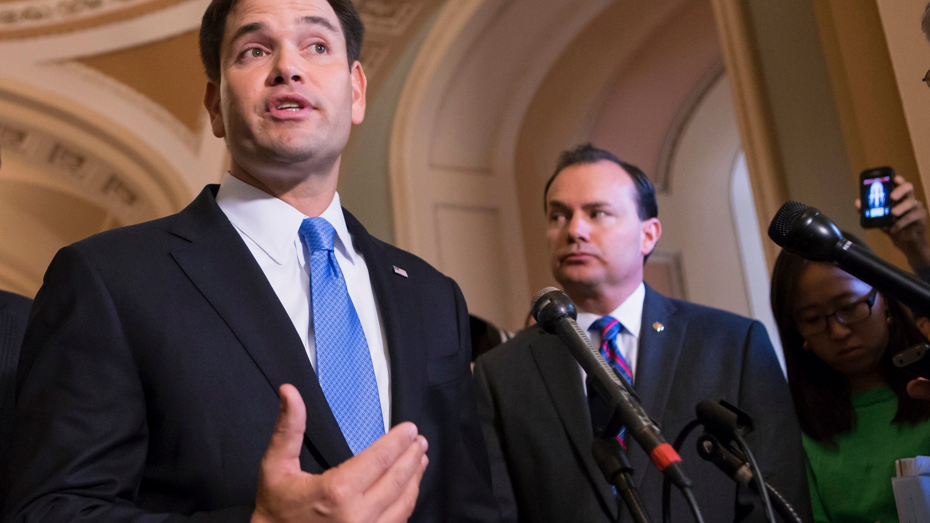 FILE - In this Sept. 27, 2013 file photo, Sen. Marco Rubio, R-Fla., left, accompanied by Sen. Mike Lee, R-Utah, speaks during a news conference on Capitol Hill in Washington. Rubio has seemingly spent months trying to convince skeptical Republicans to look at the other issues he’s taken up besides comprehensive immigration reform. The potential presidential candidate joined the drive to defund President Barack Obama’s health care law. He then turned to foreign policy matters and social issues such as legislative prayer. (AP Photo/J. Scott Applewhite, File)