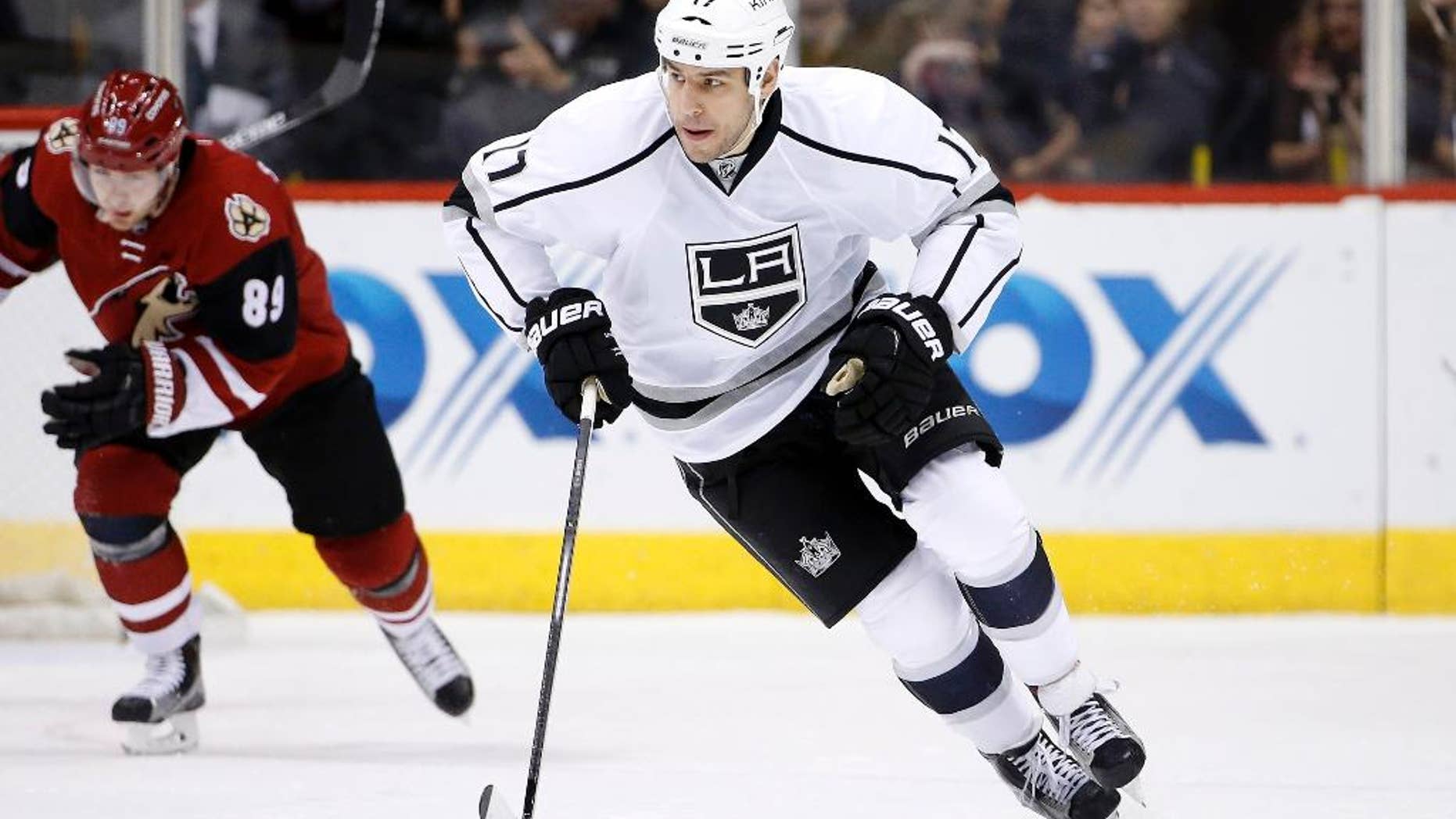 FILE- In this Feb. 2, 2016, file photo, Los Angeles Kings' Milan Lucic (17) skates with the puck during an NHL hockey game in Glendale, Ariz. The New Jersey Devils have acquired former No. 1 overall draft pick Taylor Hall from the Edmonton Oilers for defenseman Adam Larsson, which the teams announced Wednesday, June 29, 2016, two days before the start of free agency. The Oliers get salary cap space to possibly sign free agent Lucic with Hall's $6 million annual salary heading to New Jersey. (AP Photo/Ross D. Franklin. File)
