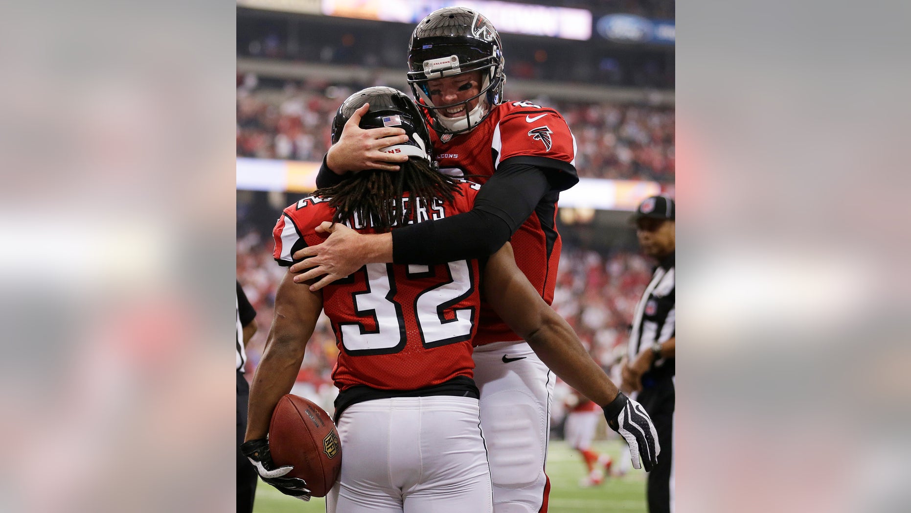 In this photo taken Sunday, Oct. 20, 2013, Atlanta Falcons quarterback Matt Ryan (2) celebrates with Jacquizz Rodgers (32) after Rodgers scored a touchdown against the Tampa Bay Buccaneers in the first half of an NFL football game in Atlanta. Ryan figured out a way to lead the Falcons out of their three-game losing streak despite having no running game and new names at wide receiver. (AP Photo/John Bazemore)