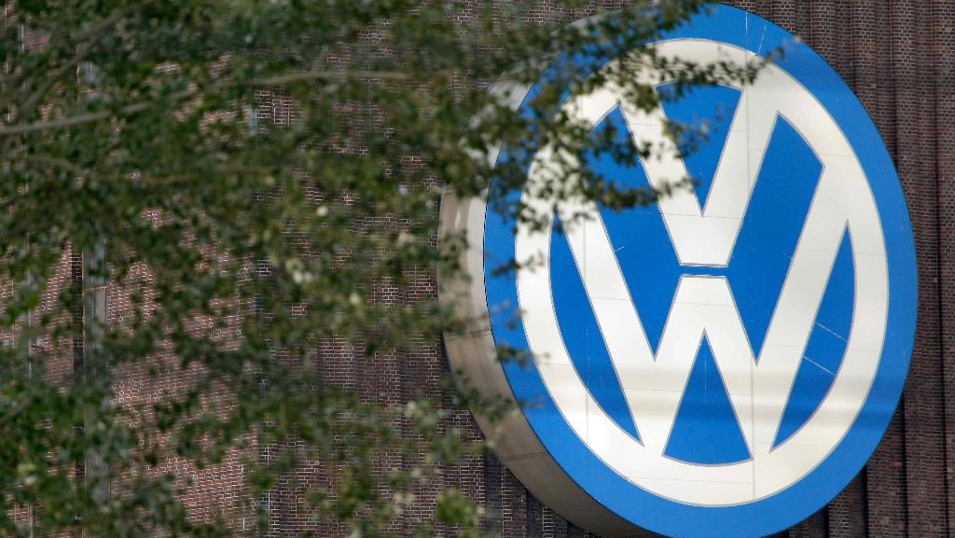 FILE - In this Sept. 26, 2015 file photo, trees stand in front of a giant logo of the German car manufacturer Volkswagen in Wolfsburg, Germany. German automaker Volkswagen is reporting better-than-expected operating earnings for the first quarter thanks to cost controls and a stronger contribution from its core brand, which was boosted by new models including the Tiguan SUV the company said Tuesday, April 18, 2017. (AP Photo/Michael Sohn,file)