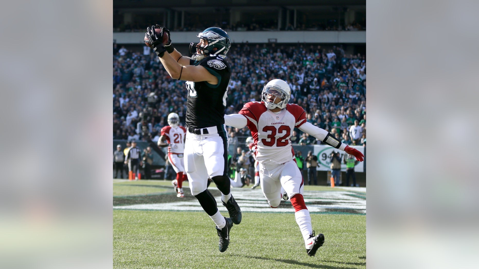 Philadelphia Eagles' Zach Ertz, left, pulls in a touchdown pass as Arizona Cardinals' Tyrann Mathieu defends during the first half of an NFL football game, Sunday, Dec. 1, 2013, in Philadelphia. (AP Photo/Matt Rourke)
