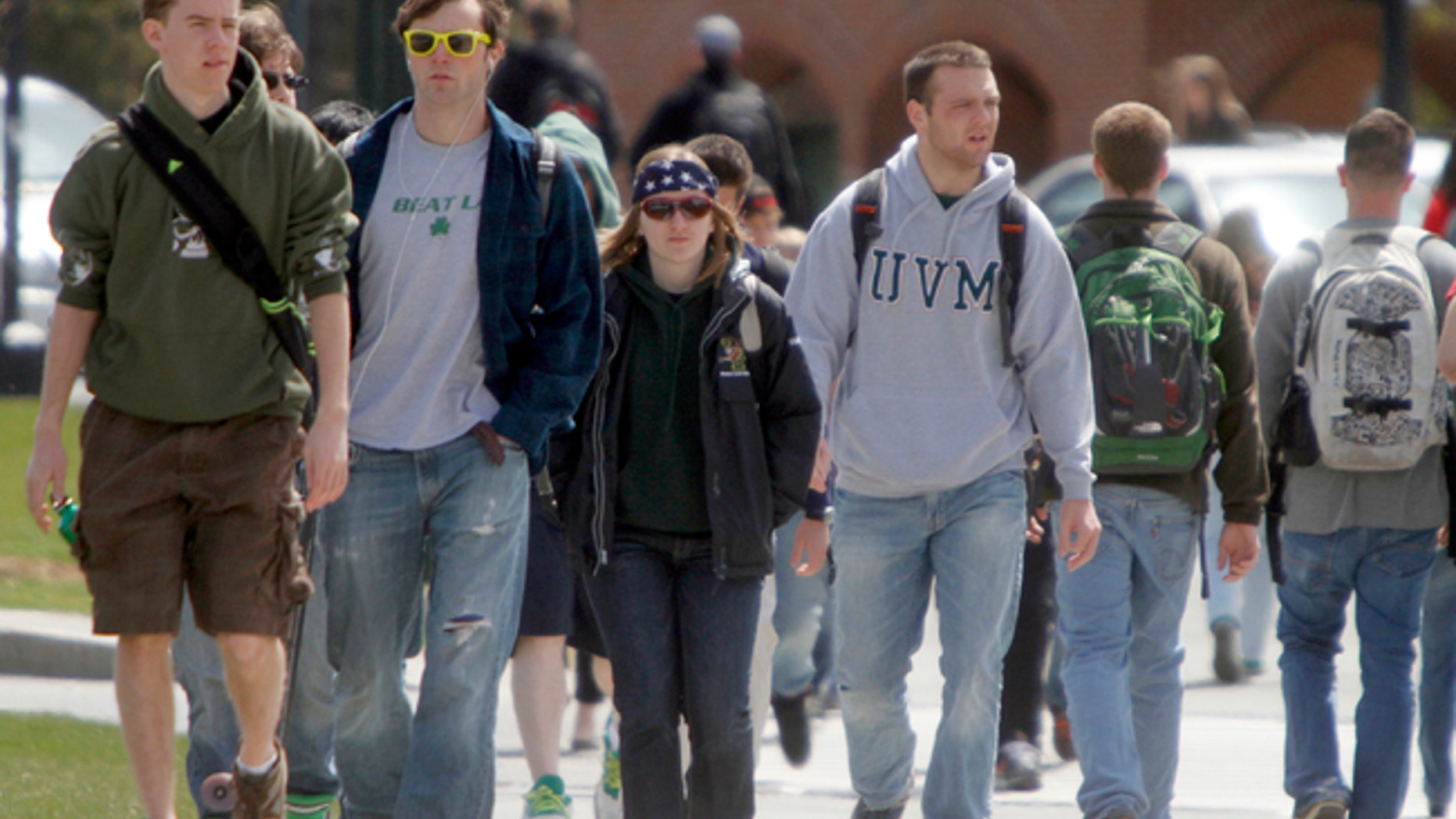 Students walk across campus at the University of Vermont on Monday, April 30, 2012 in Burlington, Vt. U.S. Rep. Peter Welch is compiling stories about student debt. Welch was at the University of Vermont on Monday where he met with students, some of whom are working multiple jobs and studying full time as they accumulate student loan debt. In Vermont, almost 70 percent of college graduates have an average of $30,000 in debt. (AP Photo/Toby Talbot)
