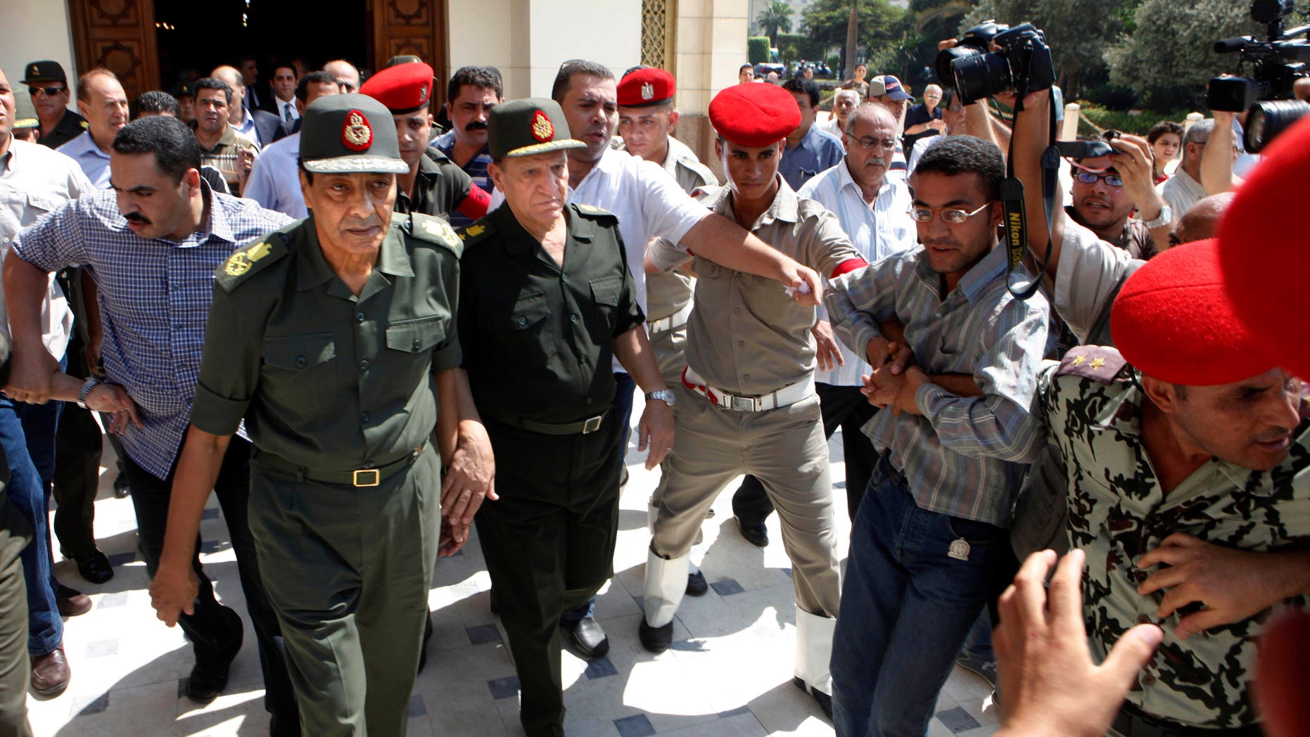 Sept. 16, 2011: Egypt's military ruler field marshal Mohammed Hussein Tantawi, left, and Sami Anan Egyptian chief of staff of the armed forces, are surrounded by military policemen and cameramen, in Cairo, Egypt.