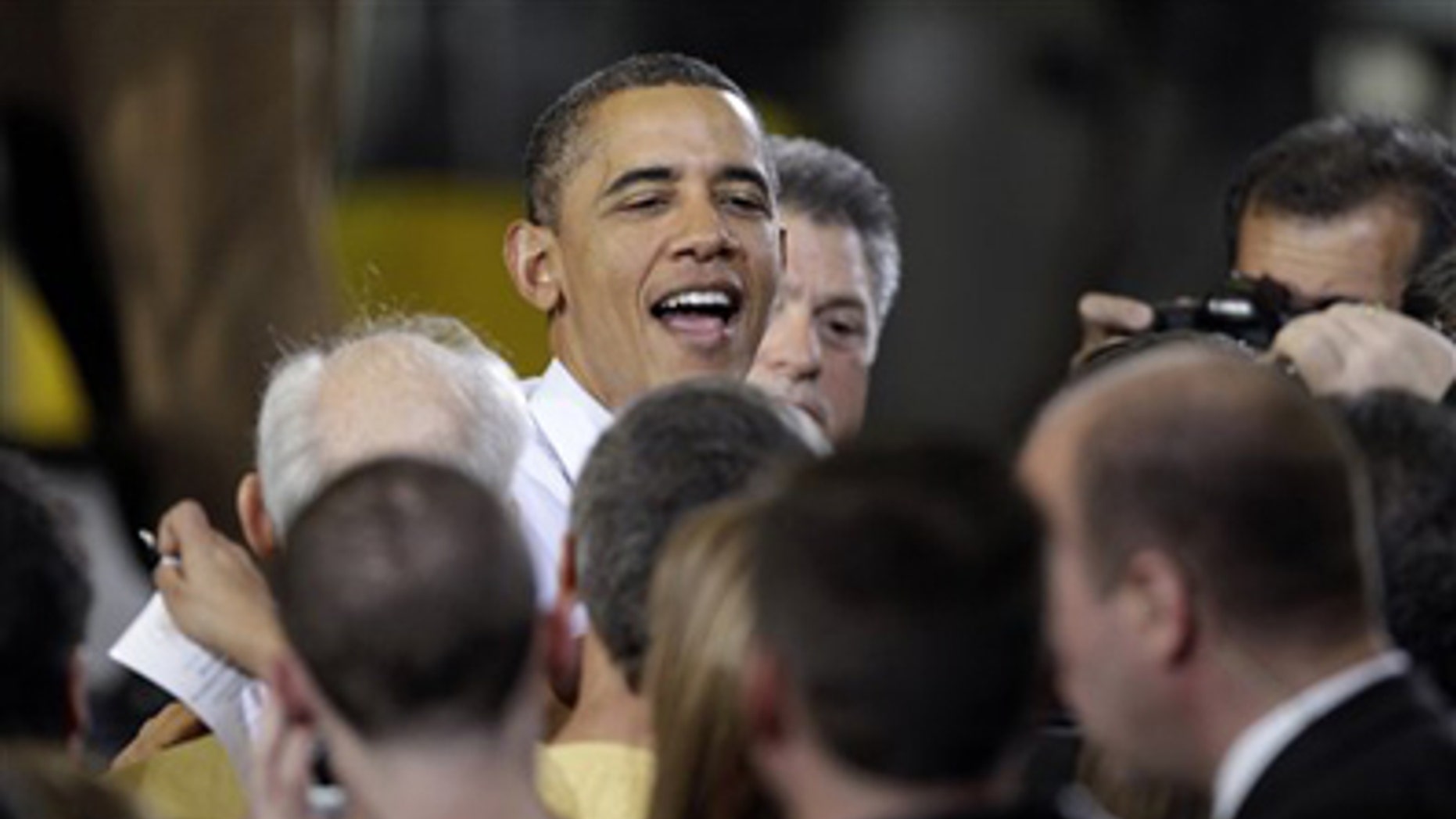Jan. 25, 2012: President Obama is greeted after speaking about manufacturing jobs, at the Conveyor Engineering & Manufacturing plant, in Cedar Rapids, Iowa.