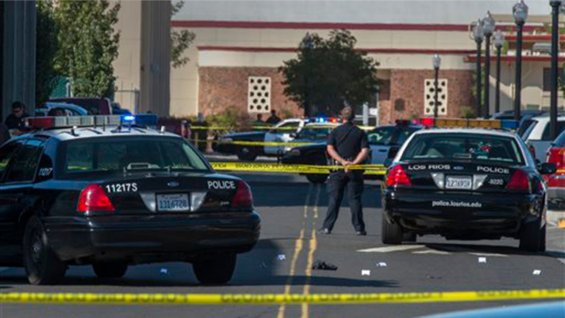 Sept. 3, 2015: A police officer stands guard as Sacramento City College was on lockdown while police search the area after a shooting.