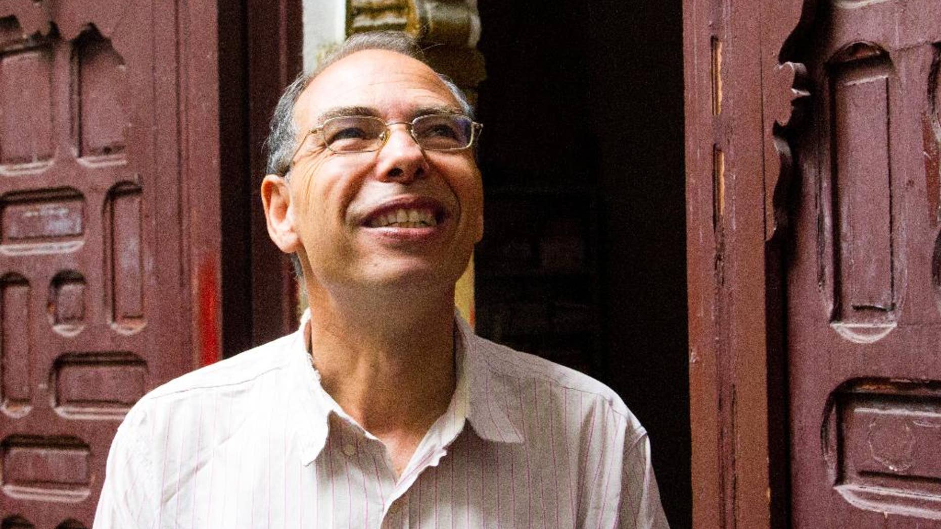 Moroccan historian and journalist Maati Monjib stands outside the local headquarters of a human rights group in Rabat, Morocco, Thursday Sept. 17, 2015. Monjib said Thursday he has gone on hunger strike after being banned from leaving the country because he is under investigation for harming the country’s image. (AP Photo/Paul Schemm)