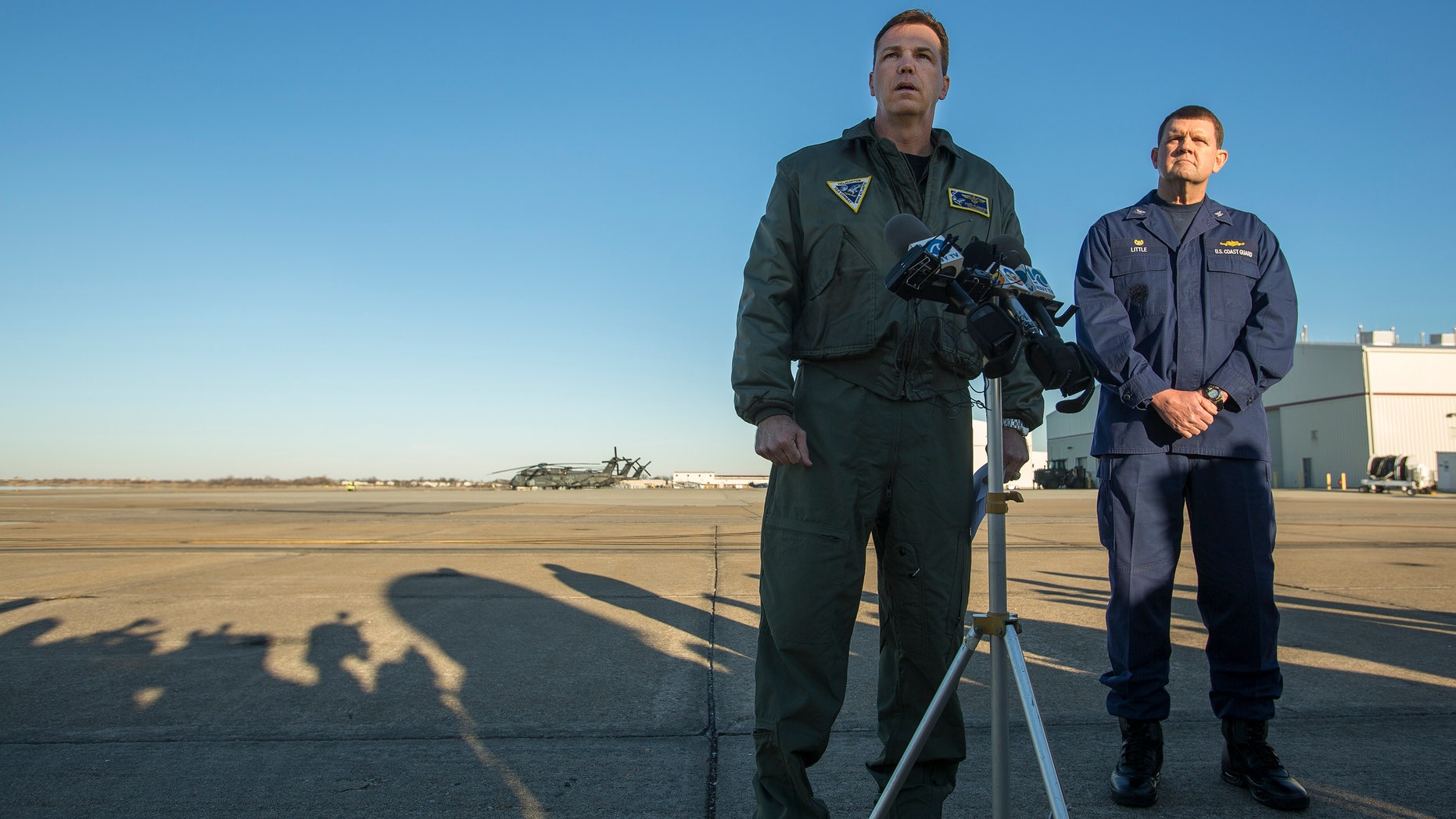 Navy Cmdr. Todd Flannery, left, Cmdr. Helicopter Sea Combat Wing Atlantic, and U.S. Coast Guard Capt. John K. Little, Sector Commander, as they answer questions about a crash of a Navy MH-53-E Sea Dragon helicopter into the Atlantic off Virginia Beach, Wednesday, Jan. 8, 2014, on the tarmac at the Norfolk Naval Station, Va. (AP Photo/The Virginian-Pilot, Bill Tiernan) MAGS OUT.