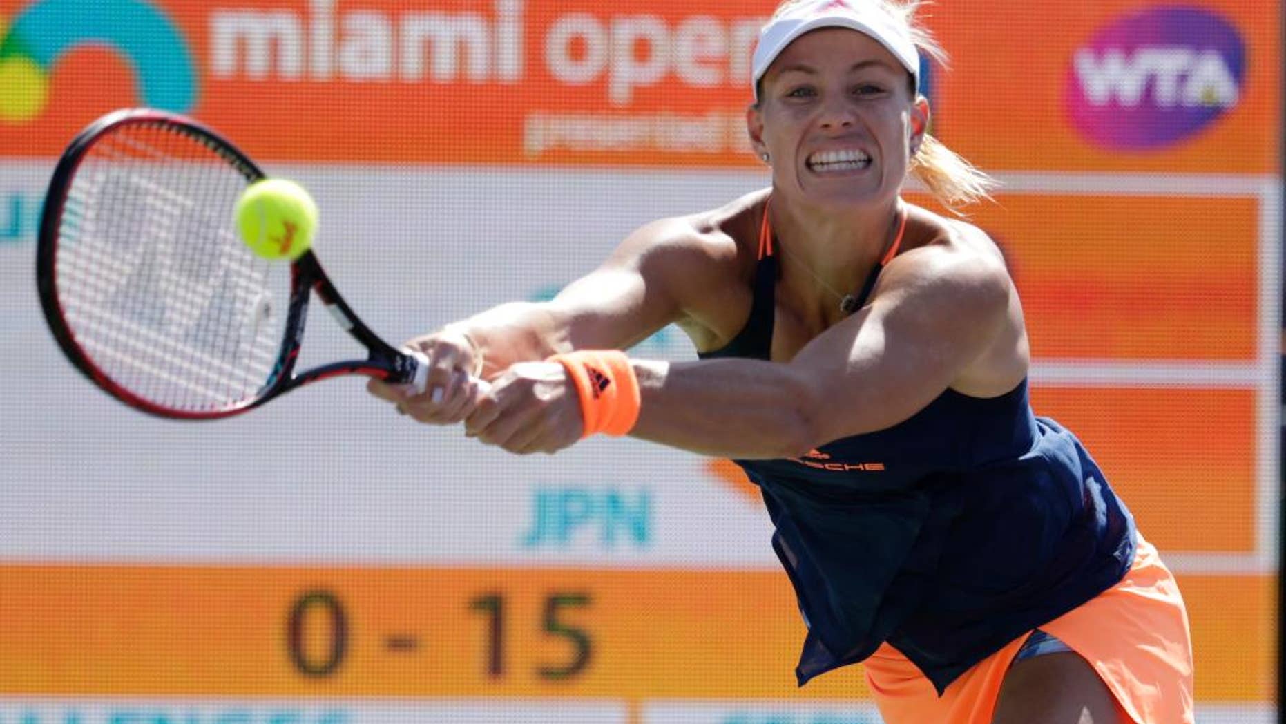 FILE - In this March 27, 2017, file photo, Angelique Kerber, of Germany, hits a return to Risa Ozaki during the Miami Open tennis tournament in Key Biscayne, Fla. Kerber is back at No. 1, replacing the pregnant Serena Williams atop the WTA rankings. Monday's May 15, 2017, move up from No. 2 represents Kerber's third stay to the top spot, for a total of 26 weeks.(AP Photo/Lynne Sladky, File)