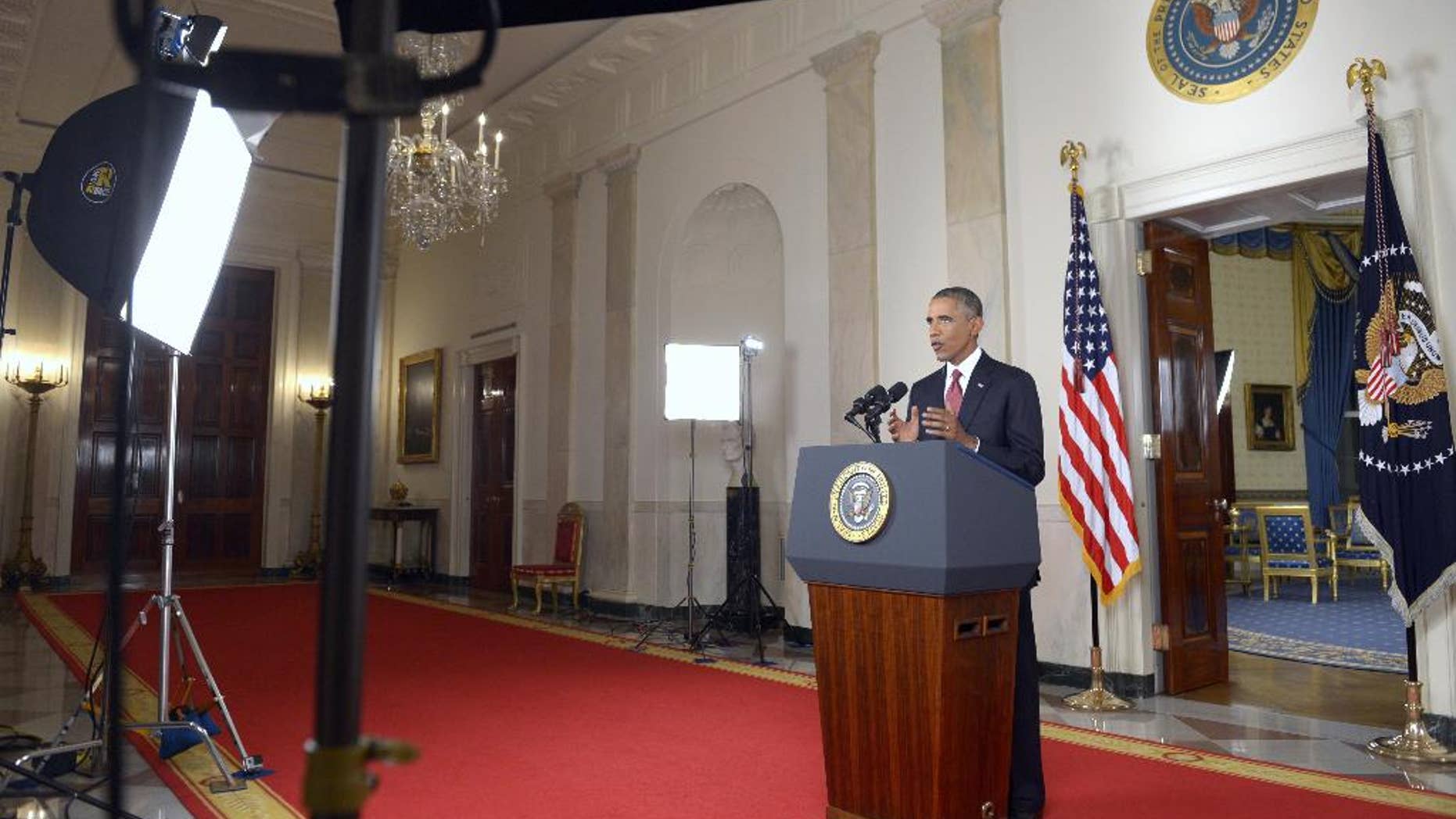 President Barack Obama addresses the nation from the Cross Hall in the White House in Washington, Wednesday, Sept. 10, 2014. In a major reversal, Obama ordered the United States into a broad military campaign to “degrade and ultimately destroy” militants in two volatile Middle East nations, authorizing airstrikes inside Syria for the first time, as well as an expansion of strikes in Iraq. (AP Photo/Saul Loeb, Pool)