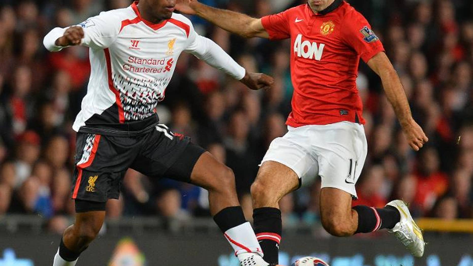 Manchester United's Ryan Giggs (right) vies with Liverpool's Daniel Sturridge at Old Trafford in Manchester on September 25, 2013