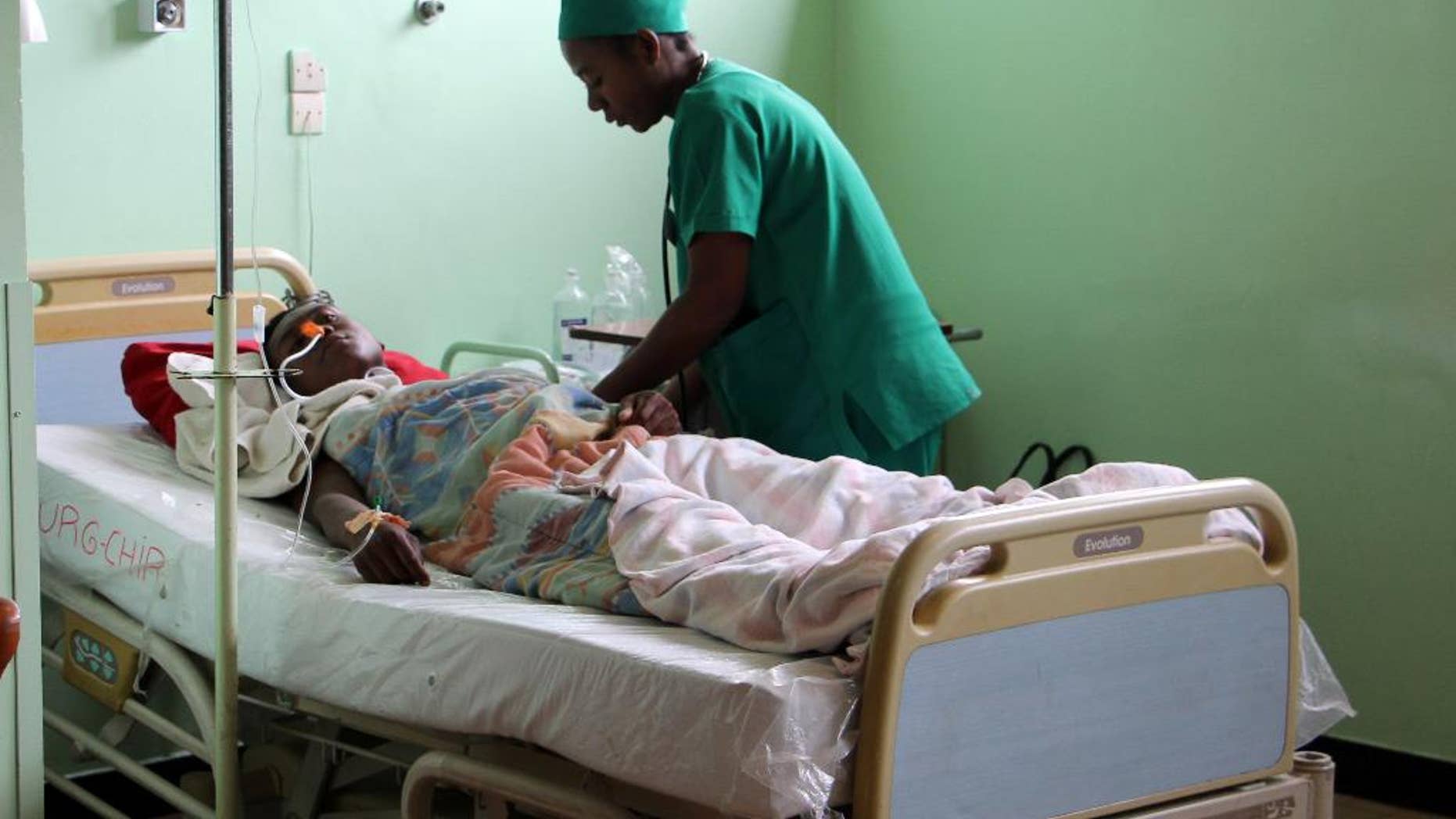 A person is treated, at a public hospital in Antananarivo, Madagascar, Monday, June 27, 2016, a day after an explosion at a stadium. A grenade exploded in a stadium in Madagascar, killing two people and injuring more than 80 in what authorities describe as a terrorist attack, authorities said Monday. (AP Photo/Jeanne Richard)