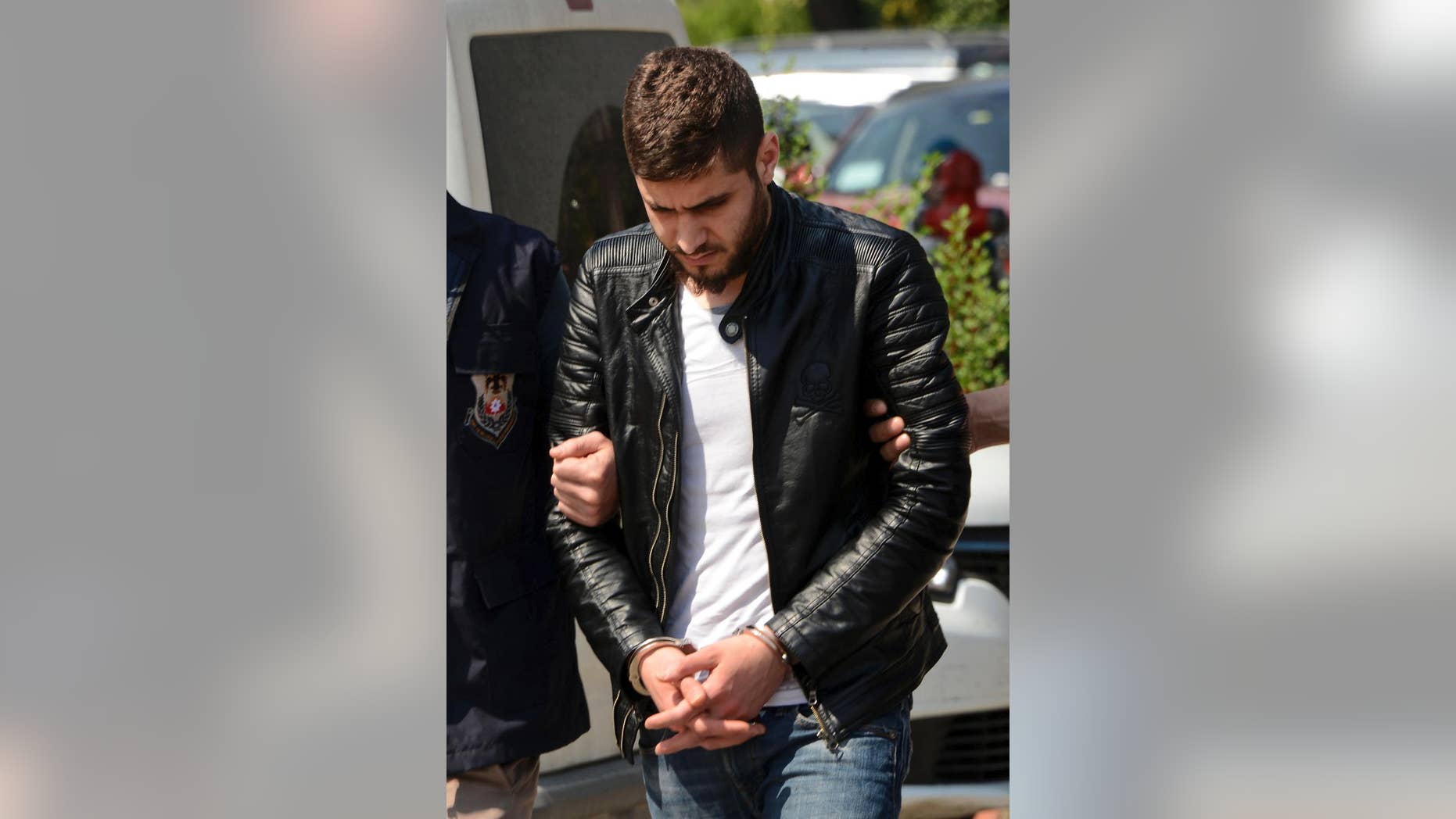 A Syrian man, identified as Safwan Qahwati, is escorted by Turkish police at a court in Adana, southern Turkey, Wednesday, March 29, 2017. Turkey's state-run news agency says authorities have arrested Qahwati, who allegedly recruited militants from European countries to fight for the Islamic State group. (Fatih Karacali/DHA-Depo Photos via AP)