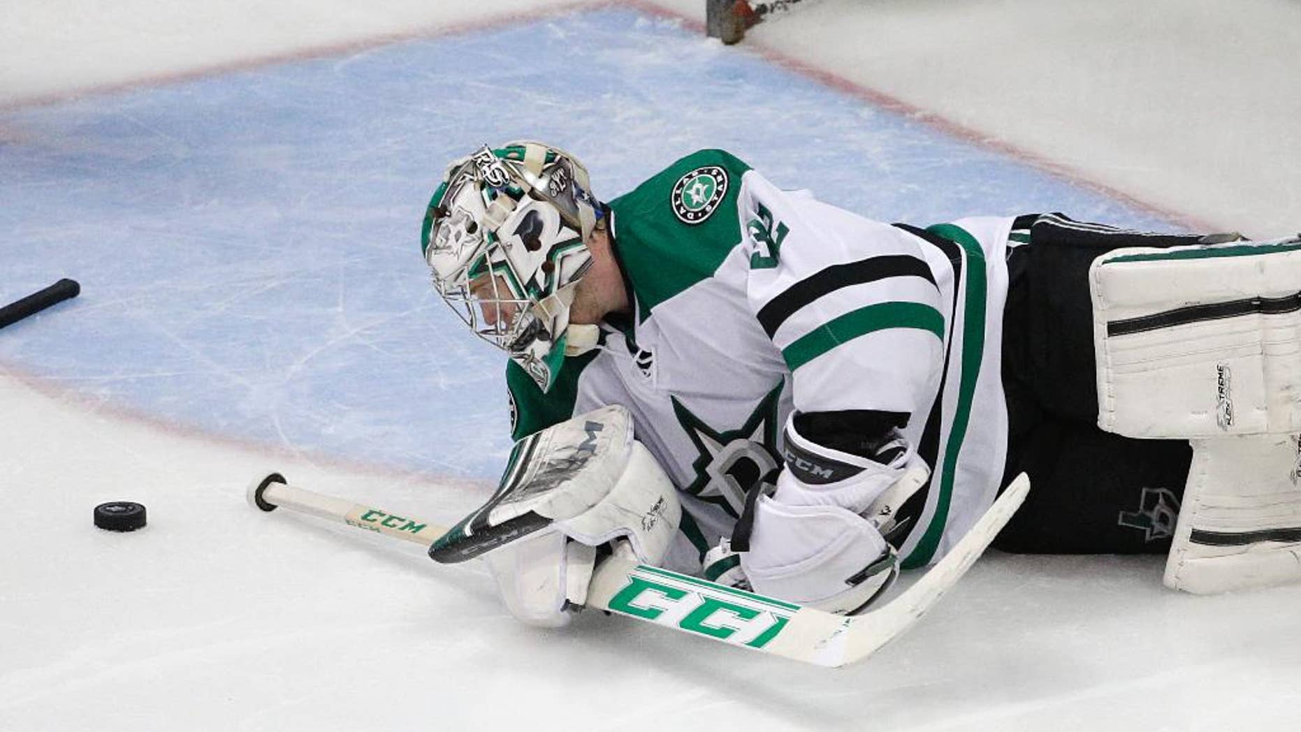 Dallas Stars goalie Kari Lehtonen, of Finland, looks at the puck after Anaheim Ducks' Andrew Cogliano scored against him during the third period in Game 2 of the first-round NHL hockey Stanley Cup playoff series on Friday, April 18, 2014, in Anaheim, Calif. The Ducks won 3-2. (AP Photo/Jae C. Hong)