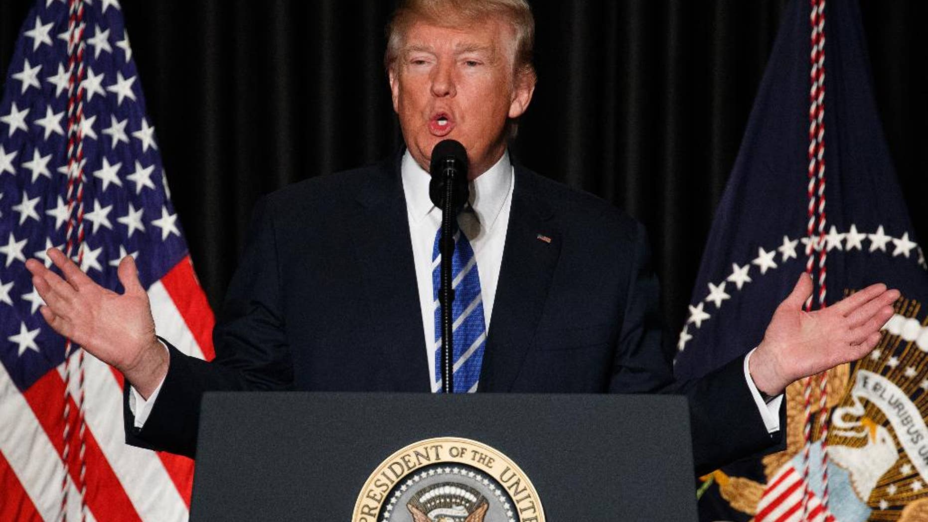 In this Feb. 8, 2017, photo, President Donald Trump speaks to the Major County Sheriffs' Association and Major Cities Chiefs Association, in Washington.Trump says it doesn’t take a lawyer to see that his order banning visitors from seven Muslim-majority nations is a “common sense” move to protect the U.S. from terrorists. He says even a bad high school student could figure that out. (AP Photo/Evan Vucci)