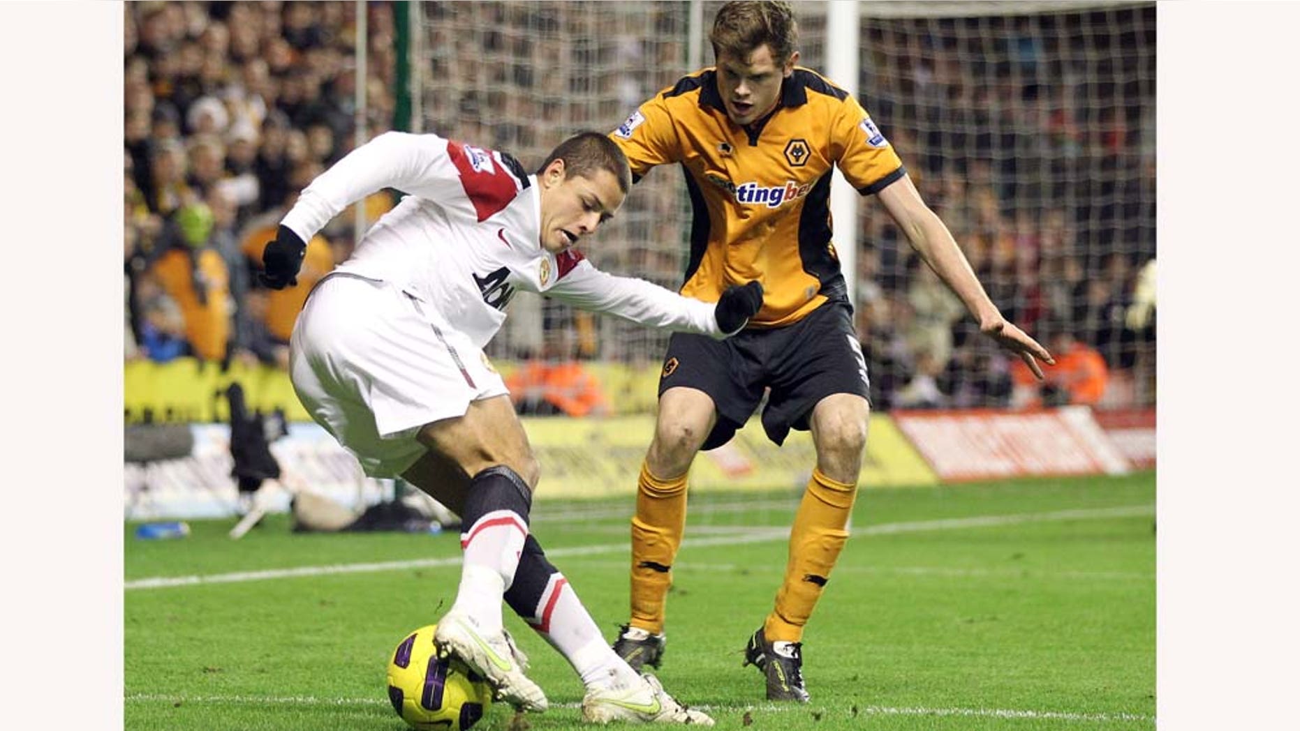 Manchester United's Javier Hernandez, left, competes for the ball with Wolverhampton Wanderers' Richard Stearman during their English Premier League soccer match at the Molineux stadium, Wolverhampton, England, Saturday, Feb. 5, 2011. (AP Photo/Simon Dawson) NO INTERNET/MOBILE USAGE WITHOUT FOOTBALL ASSOCIATION PREMIER LEAGUE (FAPL) LICENCE. CALL +44 (0) 20 7864 9121 or EMAIL info@football-datco.com FOR DETAILS