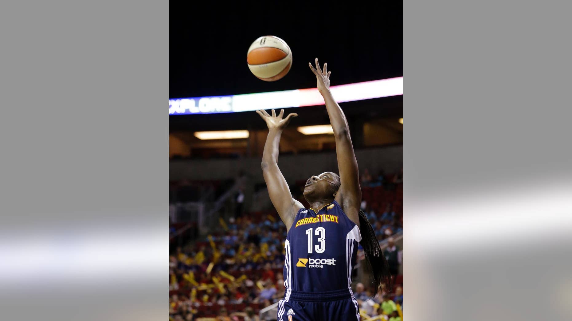 Connecticut Sun's Chiney Ogwumike grabs a rebound against the Seattle Storm during the first half of a WNBA basketball game Tuesday, July 15, 2014, in Seattle. (AP Photo/Elaine Thompson)