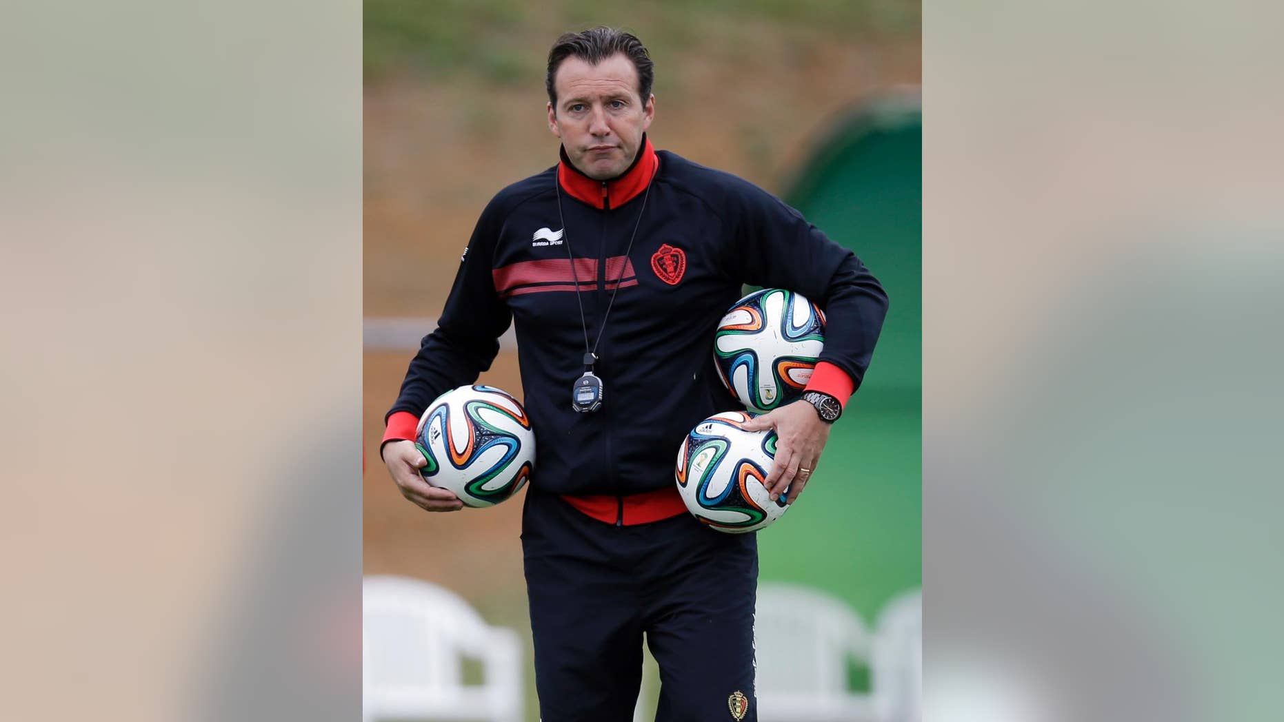 Belgium's head coach Marc Wilmots holds three balls during a training session of Belgium in Mogi Das Cruzes, Brazil, Thursday, June 19, 2014. Belgium play in group H of the 2014 soccer World Cup. (AP Photo/Andrew Medichini)