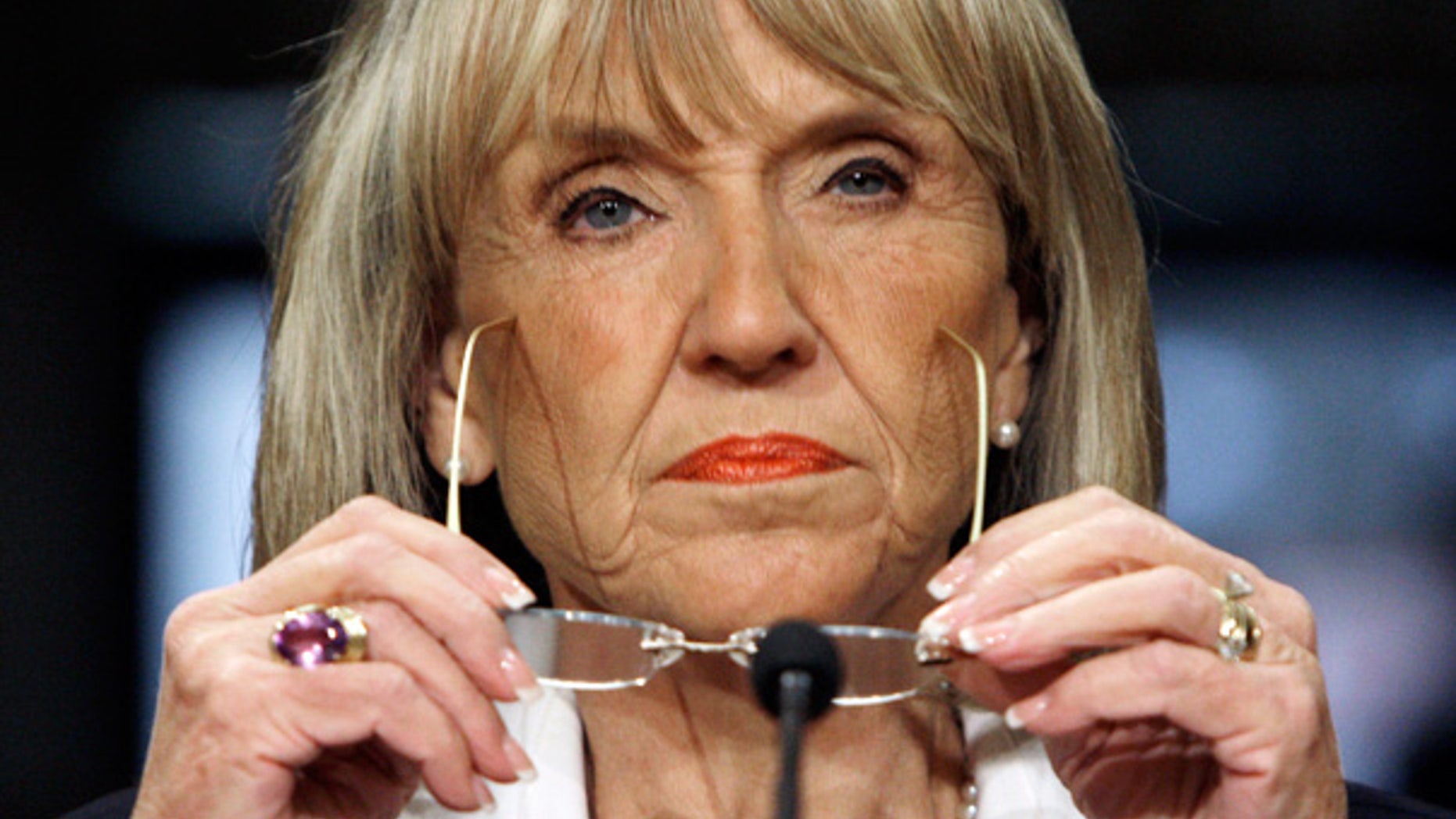 Arizona Gov. Jan Brewer listens during a meeting on violence along the U.S.-Mexico border, in Phoenix.