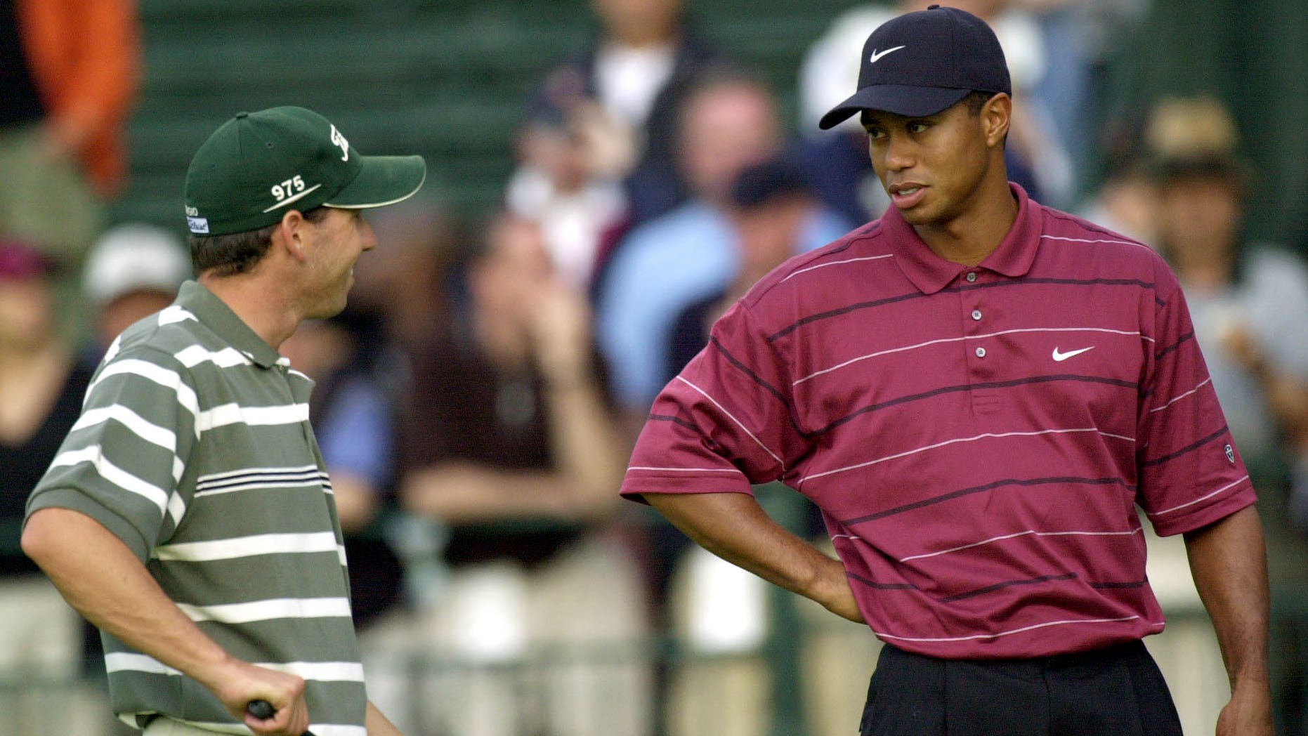 FILE - In this June 16, 2002 file photo, Sergio Garcia, left, and Tiger Woods talk on the 11th hole while waiting for play to resume after a rain delay during the final round of the U.S. Open Golf Championship in Farmingdale, N.Y. Garcia was at a European Tour awards dinner Tuesday night, May 21, 2013 when he was jokingly asked if he would have Woods over for dinner during the U.S. Open. The Spaniard replied, "We'll have him round every night. We will serve fried chicken." Woods took to Twitter on Wednesday, May 22, 2013 and said the comment wasn't silly, rather it was wrong and hurtful. (AP Photo/Dave Martin, File)