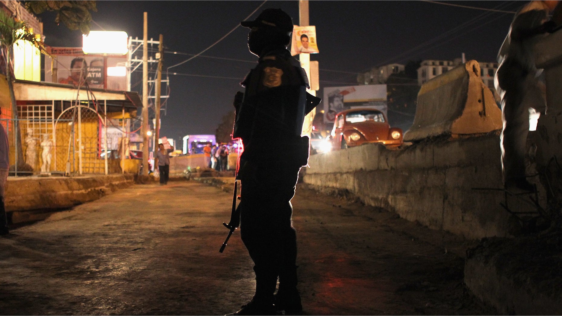 ACAPULCO, MEXICO - MARCH 01: A federal policeman stands guard at the scene of a suspected drug-related execution on March 1, 2012 in Acapulco, Mexico. Drug violence surged in the coastal resort in the last year, making Acapulco the second most deadly city in Mexico after Juarez. One of Mexico's top tourist destinations, Acapulco has suffered a drop in business, especially from foreign tourists, due to reports of the violence. Toursim accounts for some 9 percent of Mexico's economy and about 70 percent of the output of Acapulco's state of Guerrero. (Photo by John Moore/Getty Images)