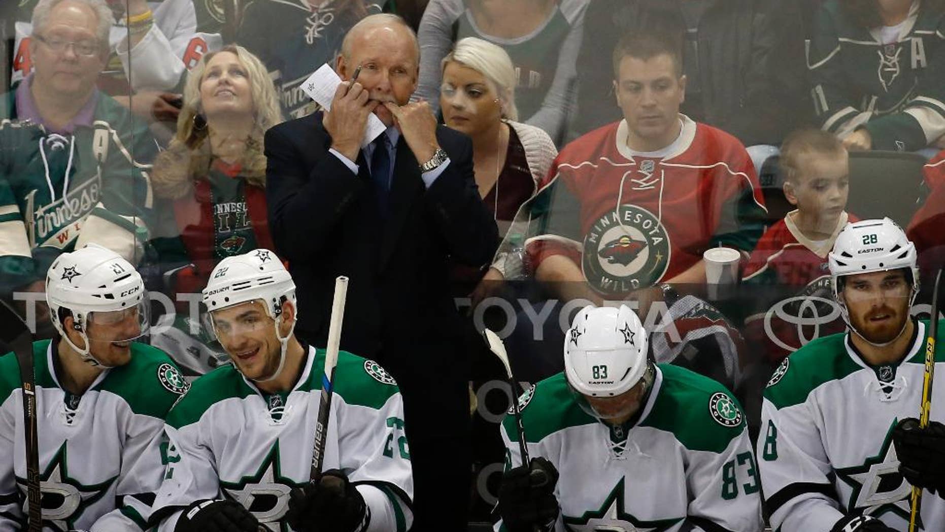 Dallas Stars head coach Lindy Ruff, top, whistles to his players during the second period of Game 6 in the first round of the NHL Stanley Cup playoffs against the Minnesota Wild in St. Paul, Minn., Sunday, April 24, 2016. The Stars won 5-4 to advance to the second round. (AP Photo/Ann Heisenfelt)