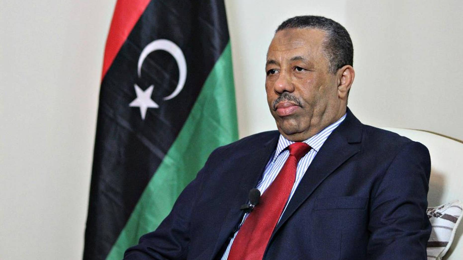 In this Wednesday, Aug. 19, 2015 photo, Prime Minister Abdullah al-Thinni listens to a question during an interview with the Associated Press in Bayda, Libya. Libya's internationally-recognized prime minister said Wednesday wants allied countries to carry out airstrikes against local Islamic State affiliates but does not want foreign ground troops, Arab or otherwise. (AP Photo/Ali Al-Shaary)