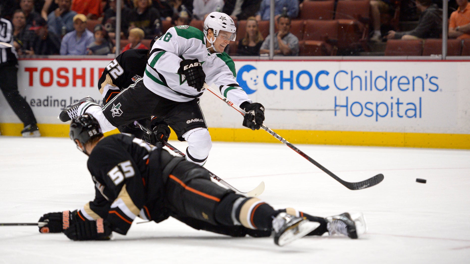 Dallas Stars center Ryan Garbutt, top, shoots and scores as Anaheim Ducks defenseman Bryan Allen defends during the first period of their NHL hockey game, Sunday, Oct. 20, 2013, in Anaheim, Calif. (AP Photo/Mark J. Terrill)