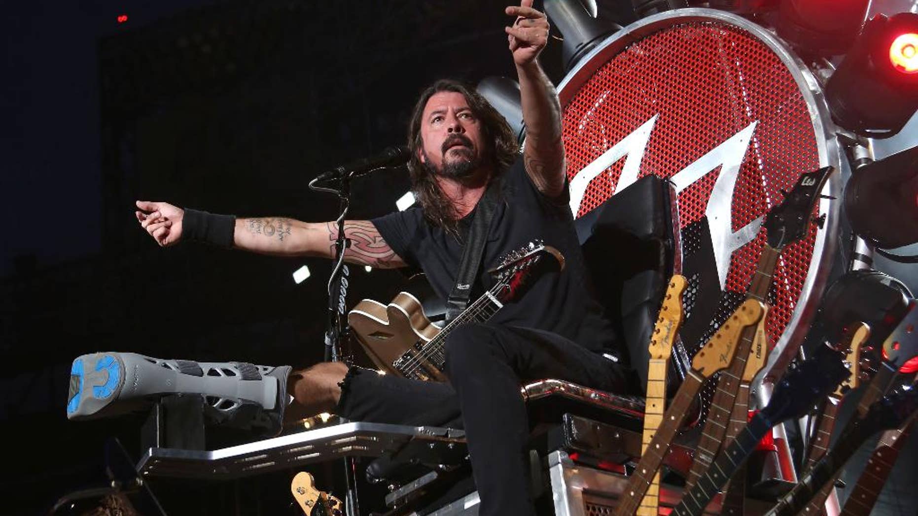 FILE - In this July 15, 2015 file photo, Dave Grohl of the Foo Fighters performs at Citi Field in New York. The band is suing insurers for failing to reimburse them for European shows they canceled following the Paris terrorist attacks in November. (Photo by Greg Allen/Invision/AP, File)