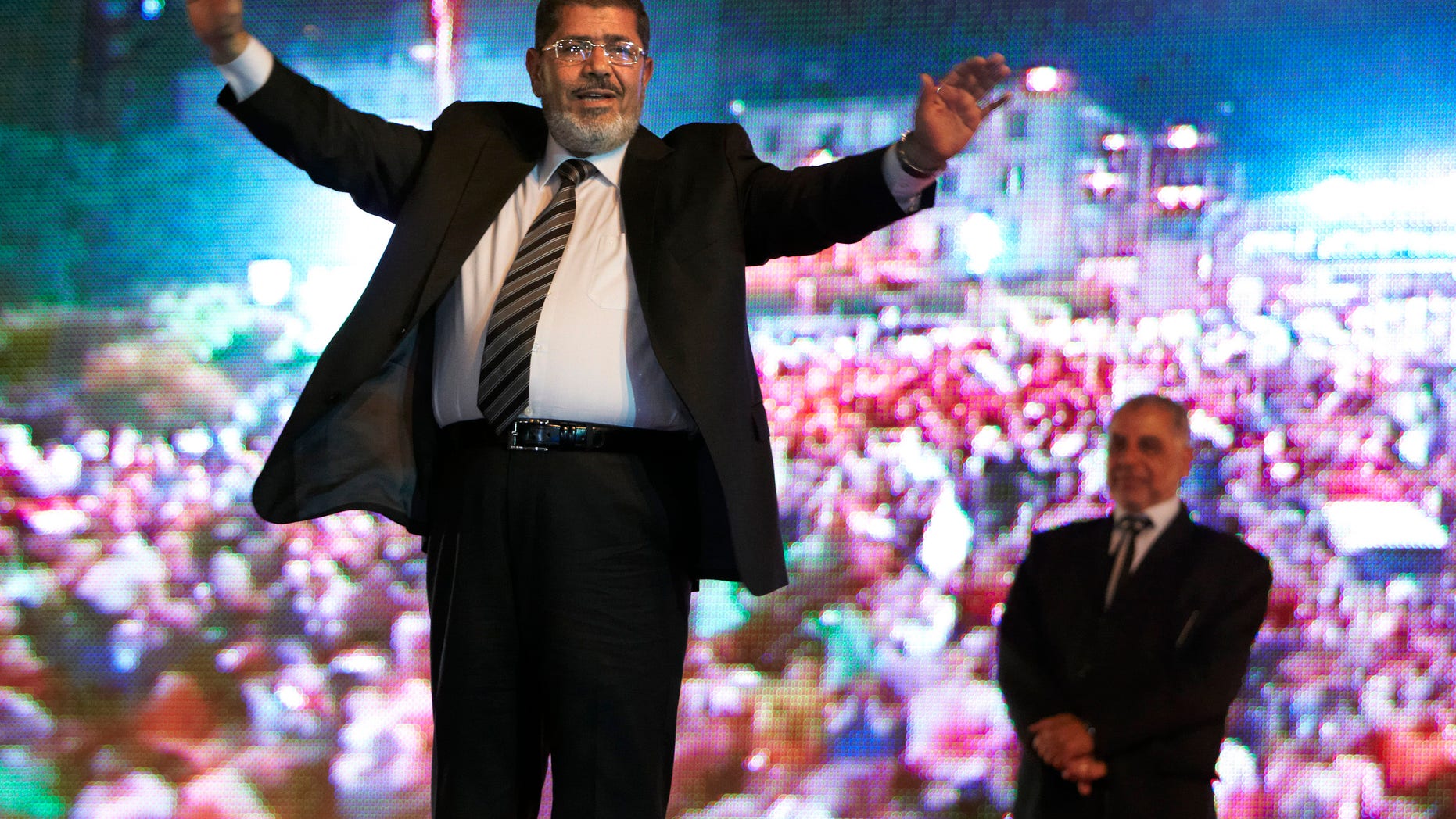 FILE - In this Sunday, May 20, 2012 file photo, then Muslim Brotherhood's presidential candidate Mohammed Morsi holds a rally in Cairo, Egypt. An Egyptian court has set Nov. 4, 2013, as the start date for the trial of ousted President Mohammed Morsi on charges of incitement to murder for the killings of opponents who were rallying outside his palace while he was in office. Morsi, ousted in a popularly-backed military coup in July, has been held incommunicado since. (AP Photo/Fredrik Persson, File)