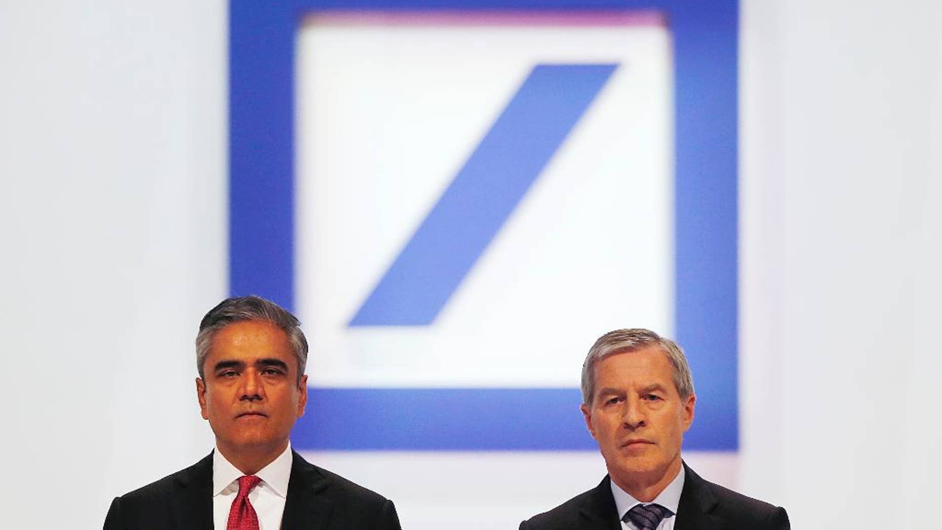FILE - In this May 22, 2014 file photo Co-CEOs of Deutsche Bank Anshu Jain, left, and Juergen Fitschen pose for photographers during the annual shareholders meeting in Frankfurt, Germany. Deutsche Bank said Sunday, June 7, 2015 that Jain and Fitschen will resign. John Cryan will succeed Jain in July 2015 and will become the sole CEO in May 2016. (AP Photo/Michael Probst, file)
