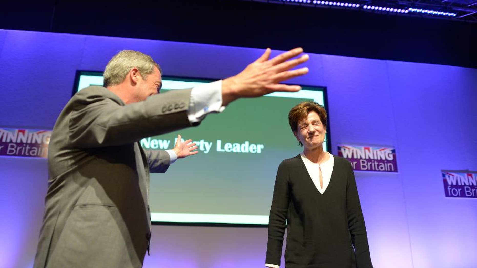 Diane James celebrates with Nigel Farage after being named as the new leader of the UK Independence Party at the party's annual conference in Bournemouth, England, Friday, Sept. 16, 2016. Britain’s right-wing U.K. Independence Party has chosen European Parliament member Diane James as its leader, replacing the charismatic but divisive Nigel Farage. James defeated four other candidates in a ballot of party members. (Ben Birchall/PA via AP)