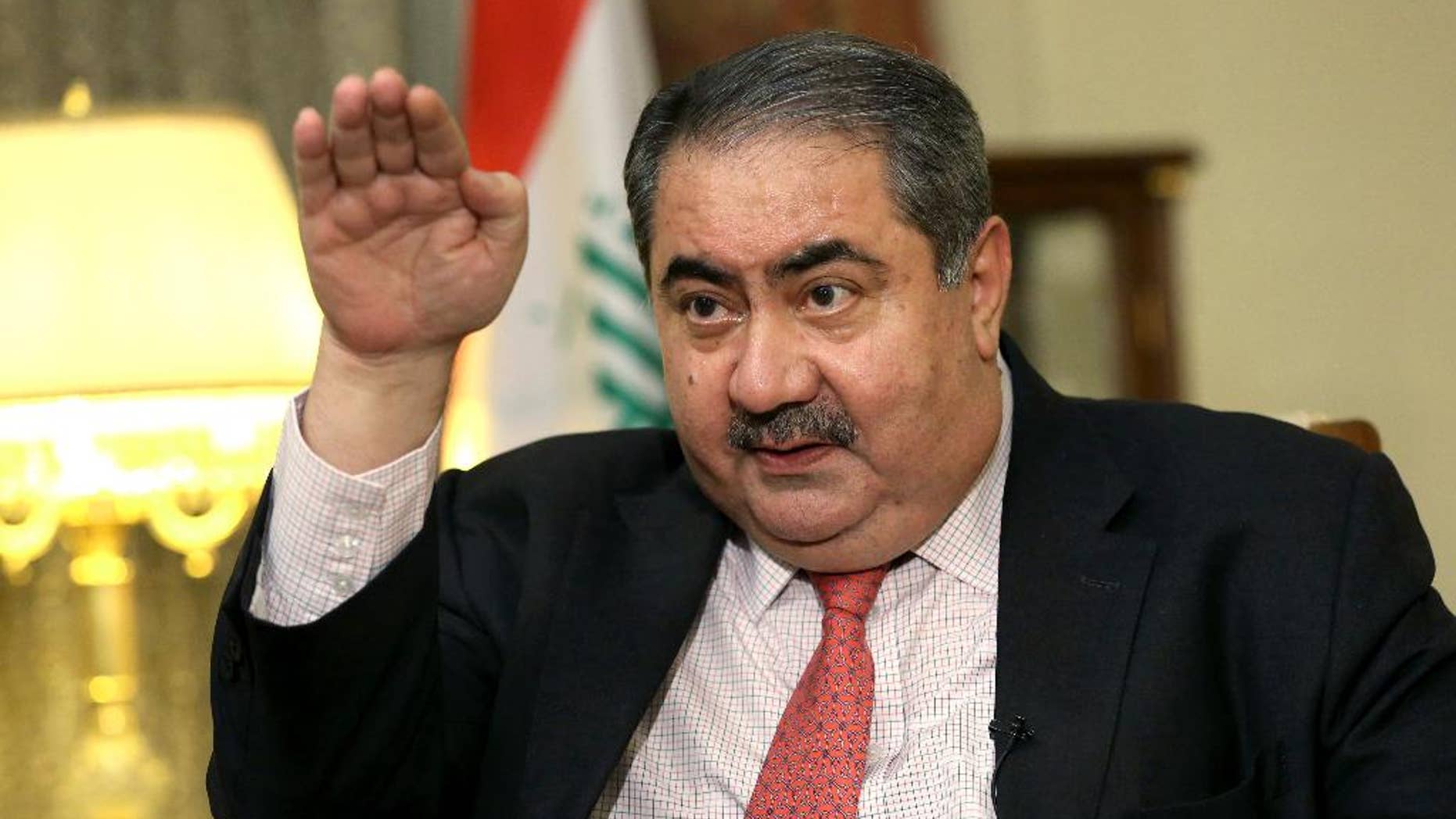 FILE - In this Dec 3, 2014 file photo, Iraq's Finance Minister Hoshyar Zebari speaks during an interview with the Associated Press in Baghdad, Iraq. Iraq's parliament has dismissed the finance minister after a no-confidence vote linked to allegations of corruption and mismanagement. The removal of Zebari, a former foreign minister and prominent Kurdish politician who has denied any wrongdoing, comes as Iraq is grappling with an economic crisis driven by low oil prices and the costs of battling the Islamic State group. (AP Photo/Hadi Mizban, File)