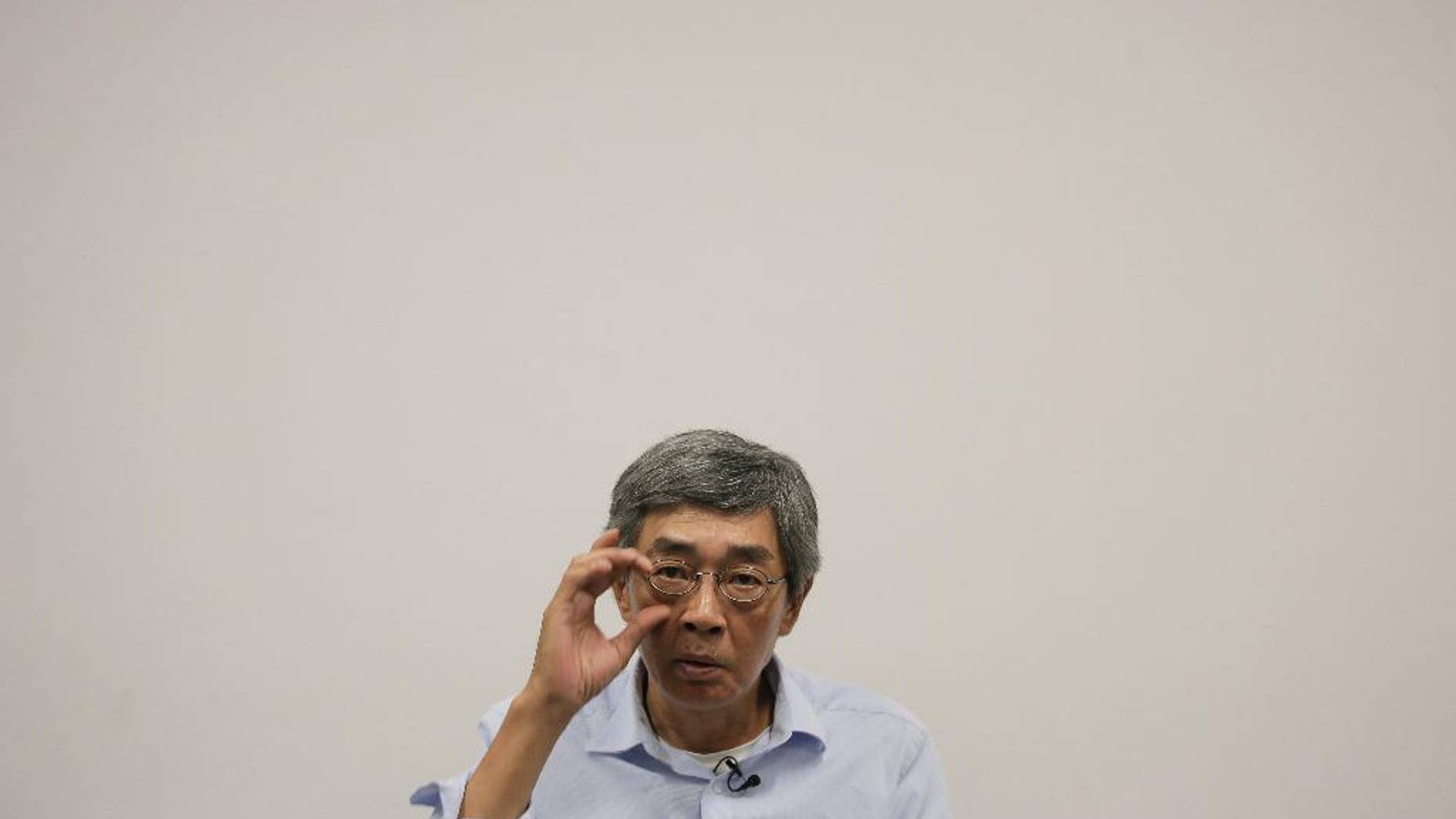 In this Sunday, June 19, 2016 photo, Hong Kong bookseller Lam Wing-kee reacts during an interview in Hong Kong. Hong Kong officials say there's little chance Lam, who is wanted in mainland China, would be sent back after mainland authorities threatened him with tougher punishment if he didn't return. (AP Photo/Vincent Yu)