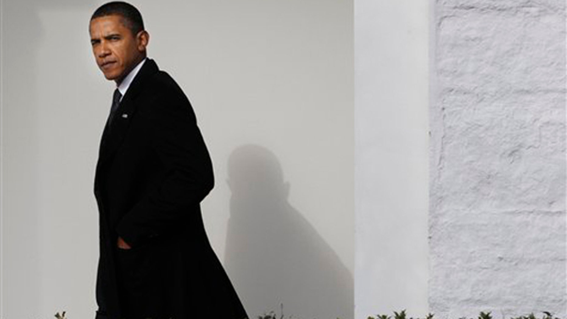 President Barack Obama walks back to the Oval Office of the White House in Washington, Tuesday, Jan. 12, 2010, after traveling to Delaware to attend the funeral services for Jean Biden, mother of Vice President Joe Biden. (AP Photo/Pablo Martinez Monsivais)