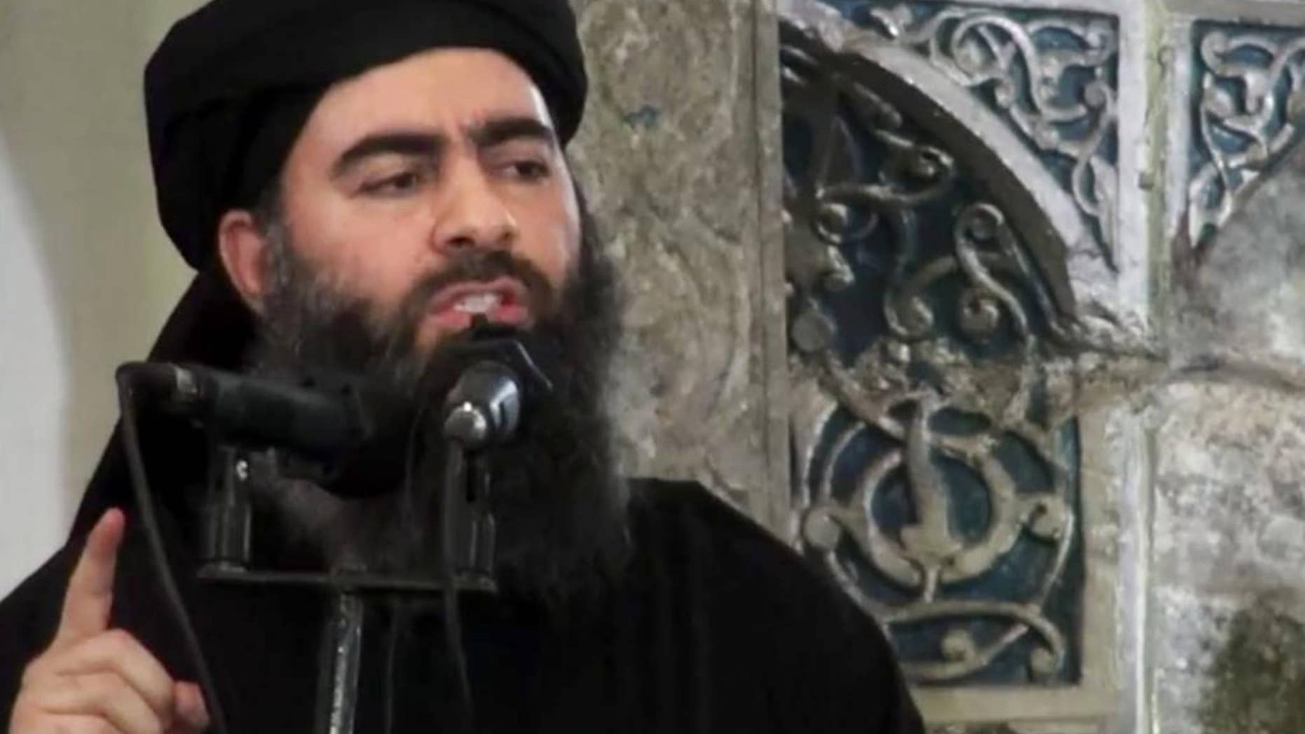 FILE - This file image made from video posted on a militant website Saturday, July 5, 2014, which has been authenticated based on its contents and other AP reporting, purports to show the leader of the Islamic State group, Abu Bakr al-Baghdadi, delivering a sermon at a mosque in Iraq. Lebanese authorities have detained a wife and son of the leader of the Islamic State group and she is being questioned, two senior Lebanese officials said Tuesday, Dec. 2, 2014. (AP Photo/Militant video, File)