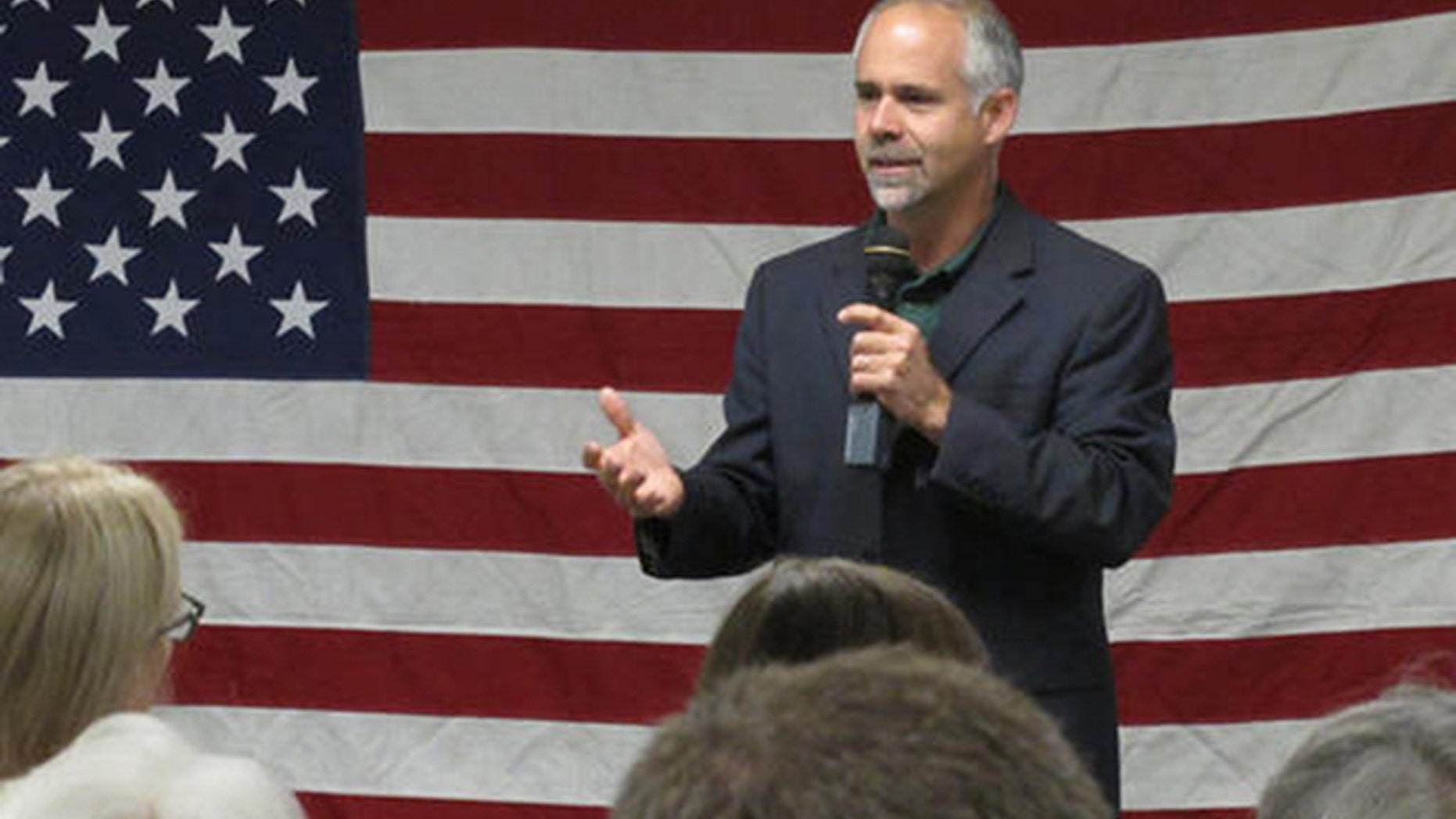 In this July 25, 2016 photo, U.S. Rep. Tim Huelskamp, R-Kan., speaks during a campaign town hall meeting at the headquarters of Patriot Outfitters, which sells firearms, accessories and hunting and military gear in St. Marys, Kan. Huelskamp is locked in a tough GOP primary race against Roger Marshall, a Great Bend obstetrician. (AP Photo/John Hanna)