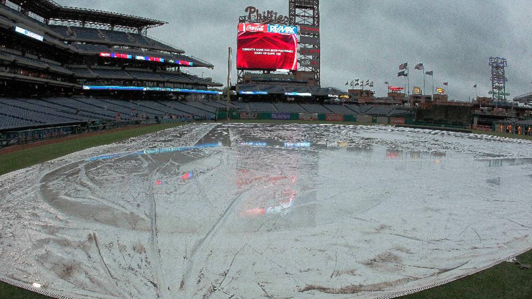 In this photo taken April 25, 2017, the rain tarp covers the infield of Citizens Bank Park in Philadelphia, where the Philadelphia Phillies baseball game against the Florida Marlins was postponed due to bad weather. That whole April showers thing went bit overboard last month in the U.S. The National Oceanic and Atmospheric Administration (NOAA) calculated that April 2017 was the country’s second wettest April on record, averaging 3.43 inches for the nation, nearly an inch above the 20th century average. Only 1957 had a slightly wetter April. Records go back to 1895. (AP Photo/Tom Mihalek)