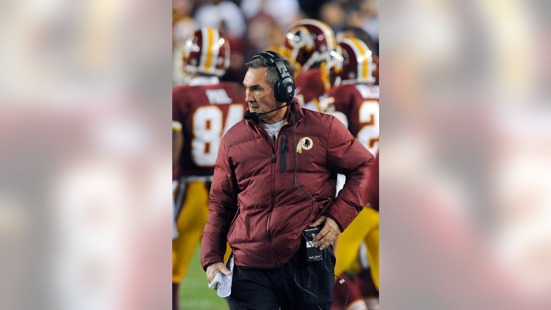 In this Sunday, Jan. 6, 2013, photo, Washington Redskins coach Mike Shanahan watches during the first half of an NFL wild card playoff football game against the Seattle Seahawks in Landover, Md. Shanahan has come under fire in the wake of Robert Griffin III reinjuring his right knee in Sunday's 24-14 wild-card loss to Seattle. The criticism has ranged from whether Shanahan cared enough for his sensational rookie to whether the natural protocol for dealing with injuries was followed. (AP Photo/Richard Lipski)