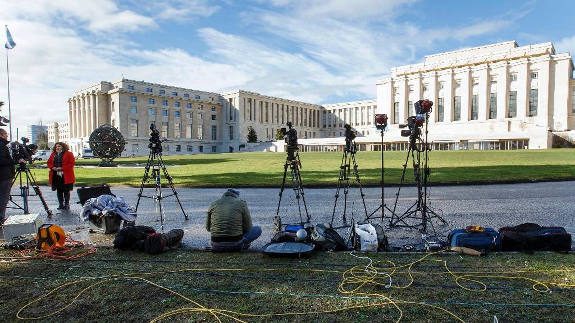 FILE - In this Monday, Feb. 1, 2016 file photo, reporters wait in front the UN building after Syria talks were rescheduled at the European headquarters of the United Nations in Geneva, Switzerland. A Taiwanese labor relations professor complained Wednesday, June 8, 2016 to the United Nations after a study group that she has regularly led was blocked from an International Labor Organization conference in Geneva. The episode highlights concerns about where and when China might seek to block Taiwanese interests in the international arena since independence-leaning President Tsai Ing-wen took office in Taiwan last month. (Salvatore Di Nolfi/Keystone via AP, file)
