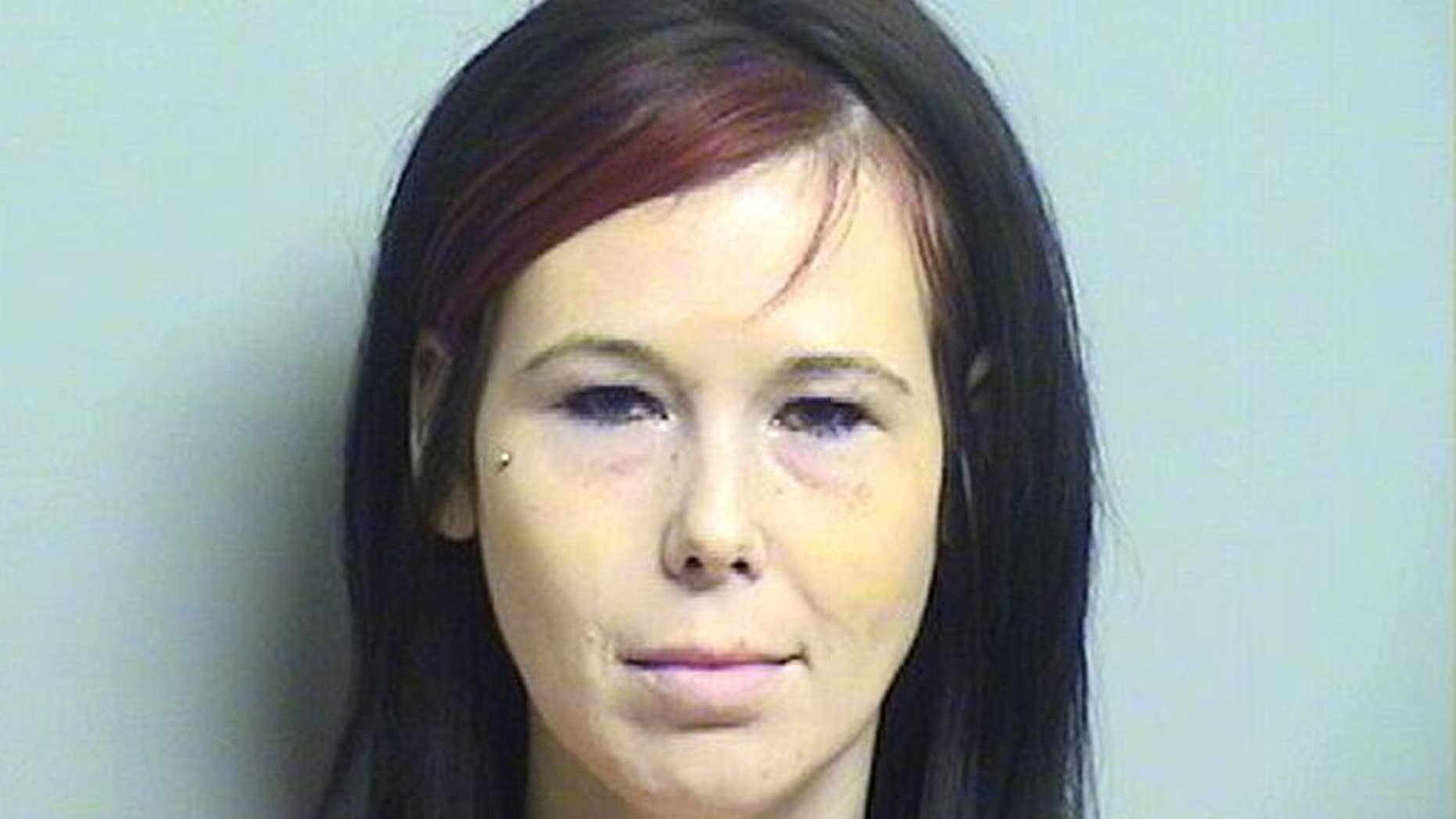 FILE - This undated file booking photo released by Tulsa County Sheriff's Office shows Shaynna Sims. Sims who has been charged with slashing the corpse of her boyfriend's ex-girlfriend during a funeral viewing has been ordered to stand trial, a Tulsa judge ruled Friday, Sept. 11, 2015. (Tulsa County Sheriff's Office via AP, File)