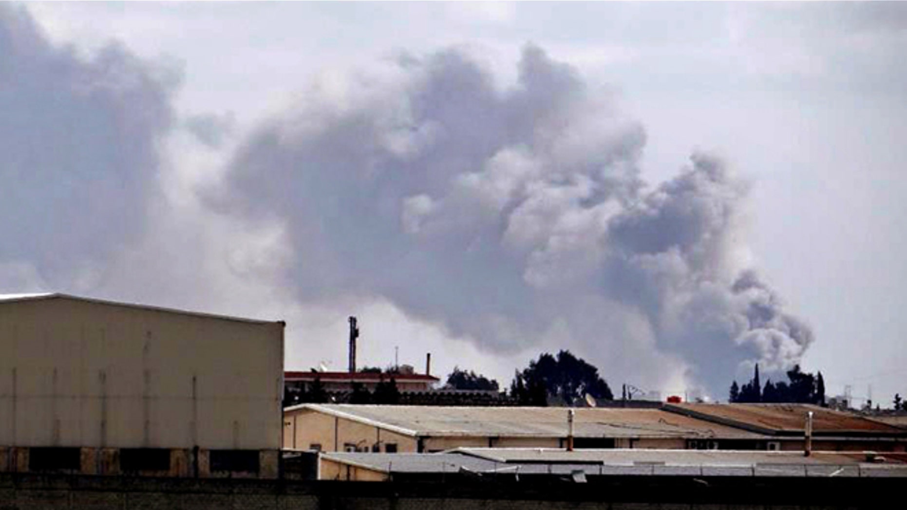 Feb. 12, 2013: Citizen journalism image provided by Aleppo Media Center AMC which has been authenticated based on its contents and other AP reporting, shows smoke rises from Aleppo International Airport, Syria.